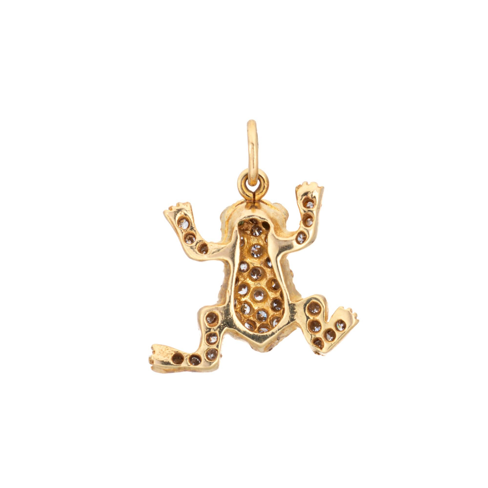 Finely detailed vintage diamond frog charm crafted in 18k yellow gold.  

Round brilliant cut diamonds total an estimated 0.20 carats (estimated at H-I color and VS2-SI2 clarity). Two emeralds total an estimated 0.02 carats. 

The sweet and petite
