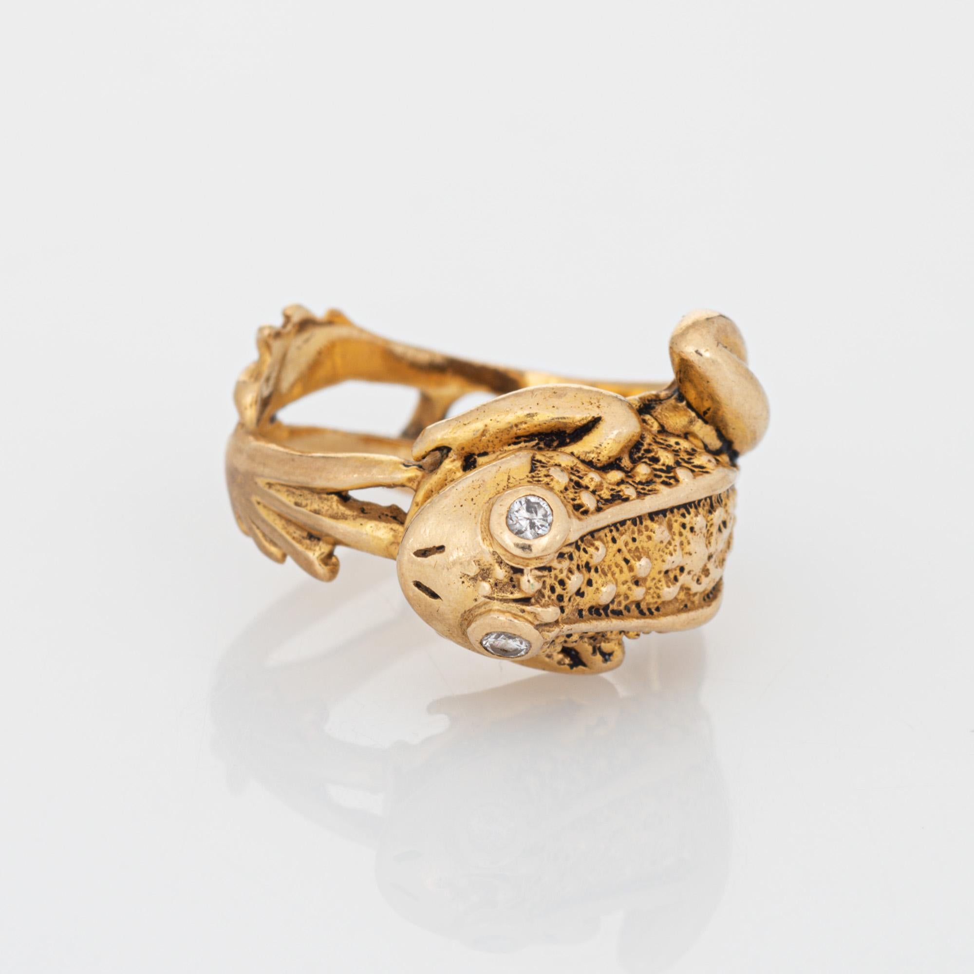 Stylish vintage frog ring (circa 1970s to 1980s) crafted in 14 karat yellow gold. 

Two estimated 0.01 carat diamonds are set into the eyes (0.02 - H-I color and I1-2 clarity). 

The finely detailed frog features textured detail to the back, diamond