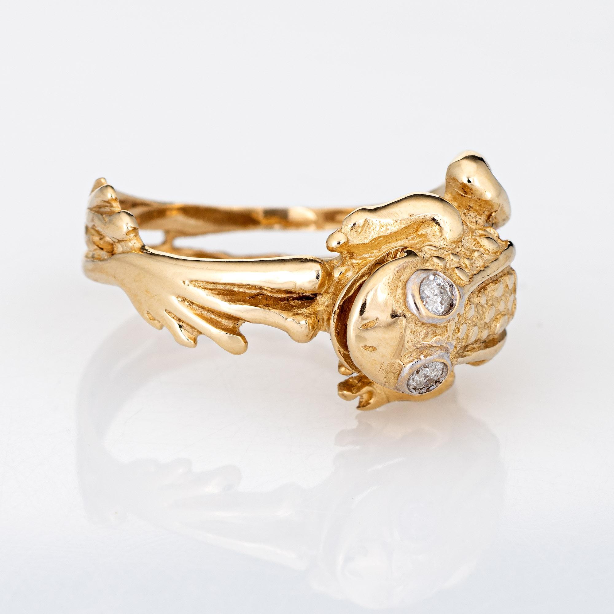 Stylish vintage frog ring (circa 1970s to 1980s) crafted in 14 karat yellow gold. 

Two estimated 0.02 carat diamonds are set into the eyes (0.04 carats - H-I color and I1-2 clarity). 

The finely detailed frog features textured detail to the back,