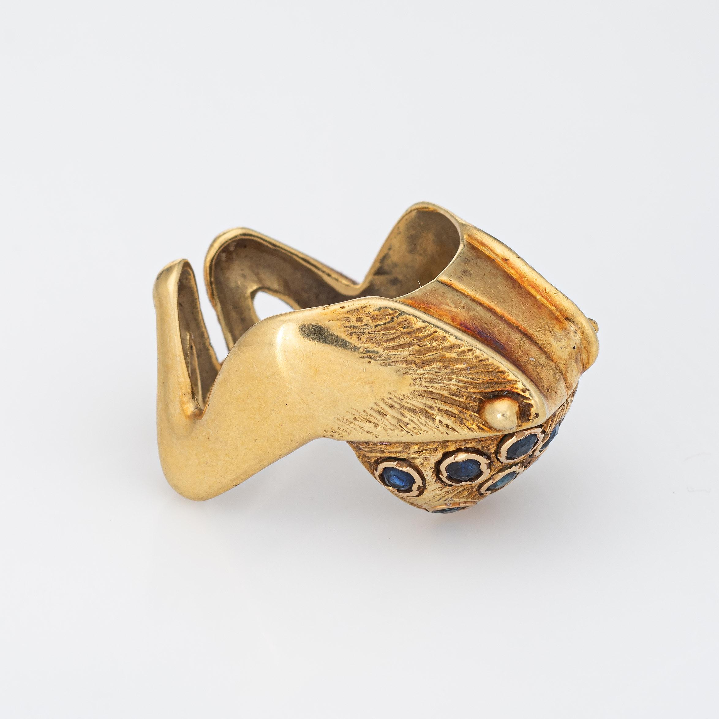 Finely detailed vintage frog ring (circa 1960s to 1970s) crafted in 18 karat yellow gold. 

13 blue sapphires are estimated at 0.05 carats each and total an estimated 0.65 carats. The sapphires are in excellent condition and free of cracks or chips.