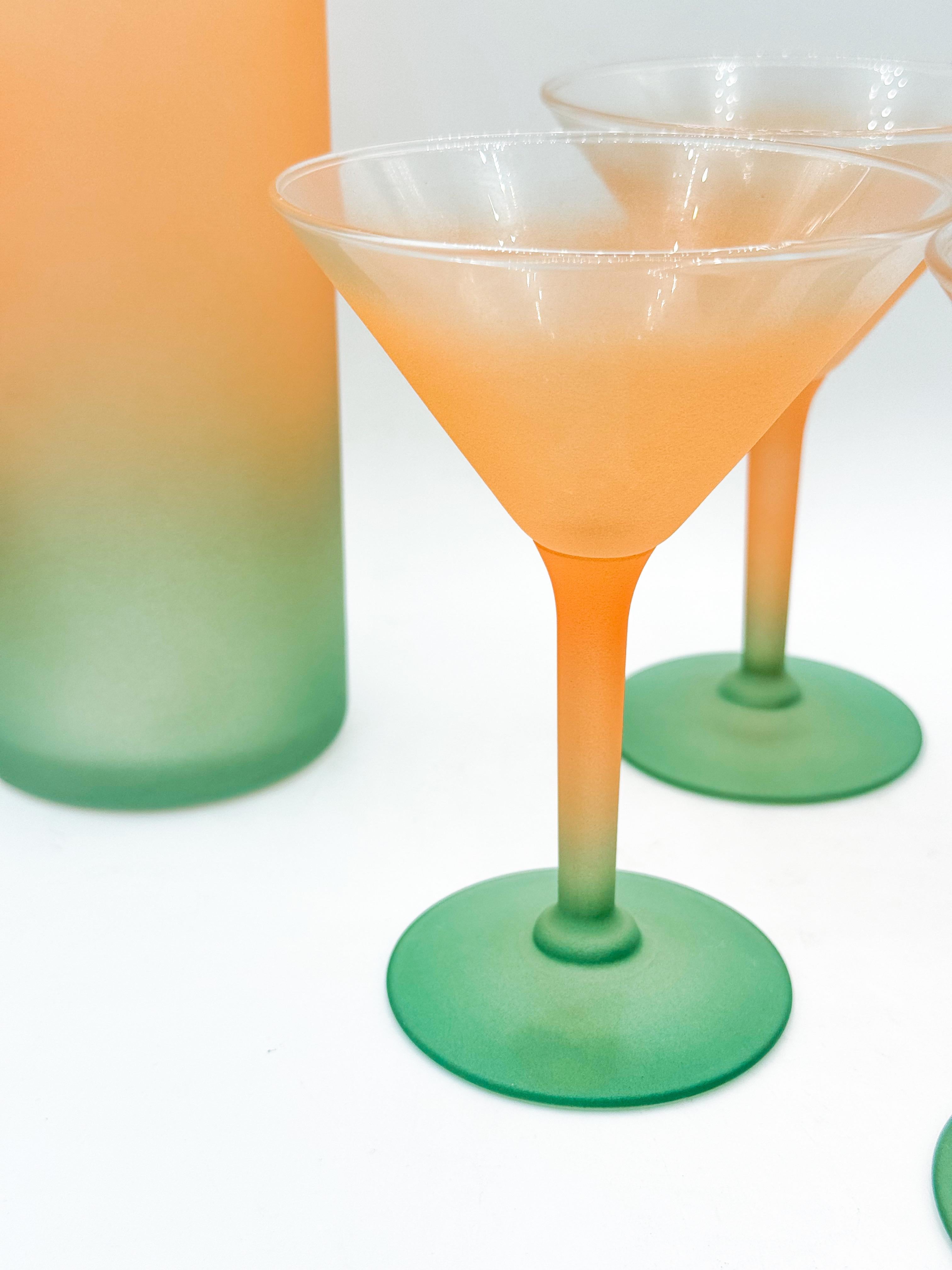 A striking five-piece frosted glass cocktail set made in Canada by Chevrier Pettigrew in the 1980s. The set includes four martini glasses and one matching pitcher, each featuring a smooth ombré gradient that fades from soft tangerine orange to sage