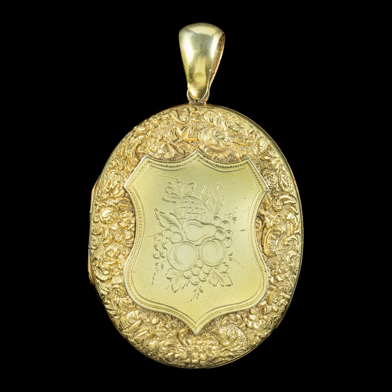 A wonderful 20th Century locket featuring intricate, floral artistry embossed across the front and a large shield in the centre etched with a collection of fruit, including grapes, peaches, a pear and pineapple.  

The piece is all solid sterling