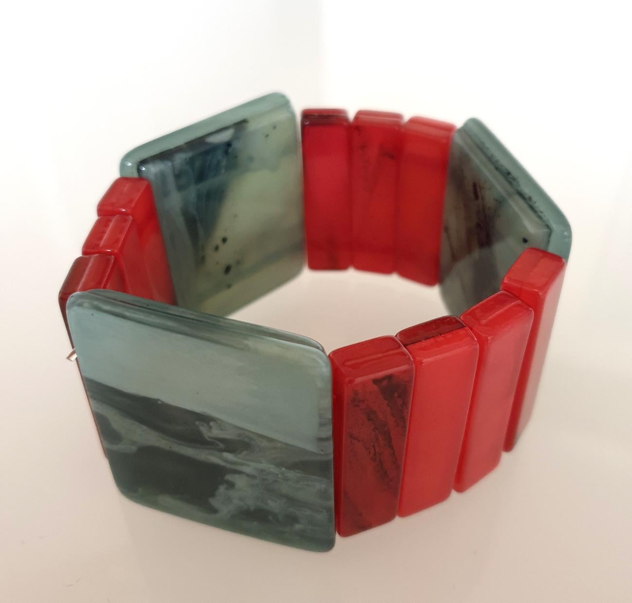 Mid Century Bakelite bracelet, France circa 1970s.
Some black veins on the Bakelite.
The Fuchsia and Blue elements are different in shape and height, 
giving a lot of style to the bracelet.
The light blue color has some gray hues.
Excellent