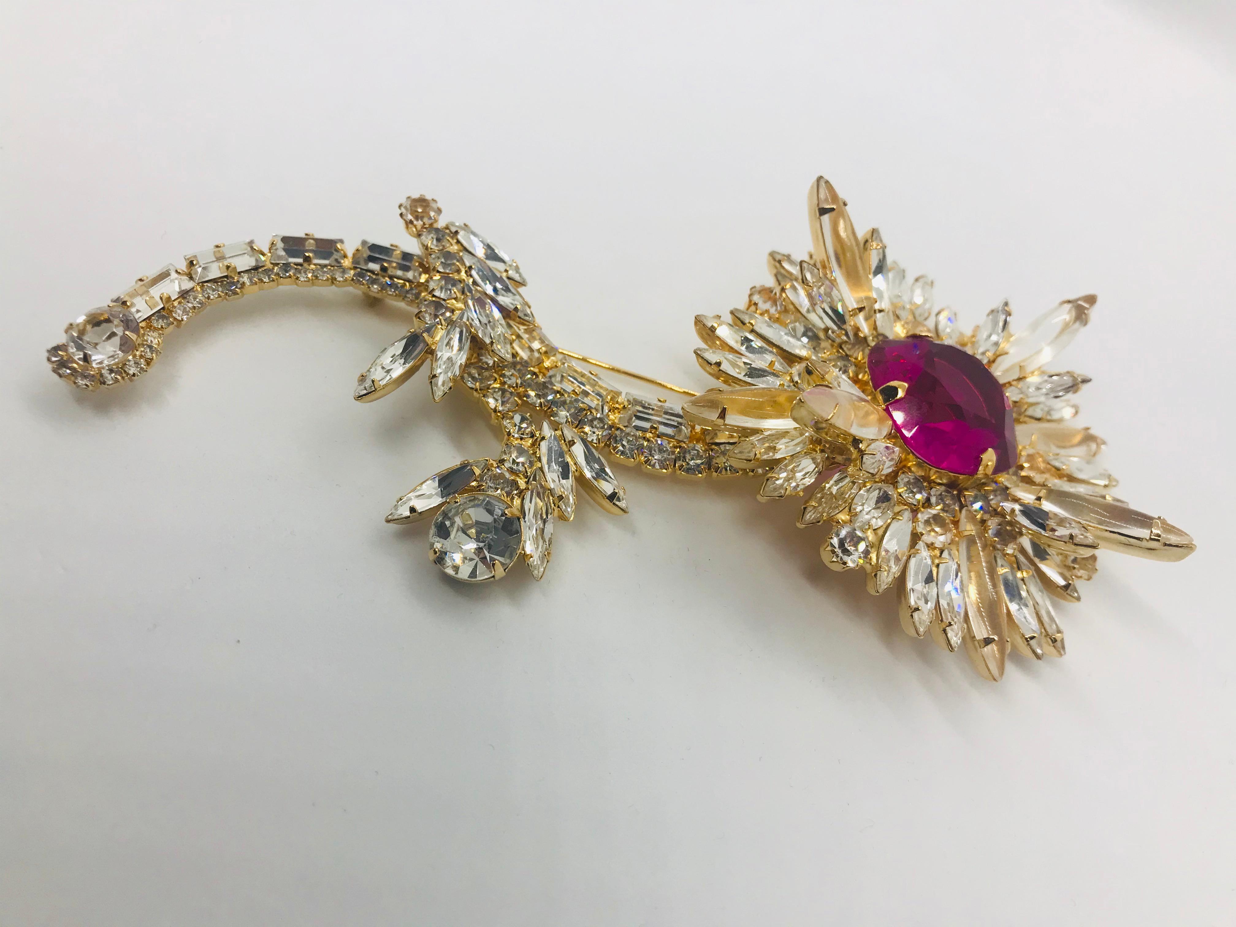 Based on a famous floral brooch from Queen Elizabeth's jewelry collection, our vintage fuchsia Swarovski crystal and clear Austrian crystal floral spray brooch is a 