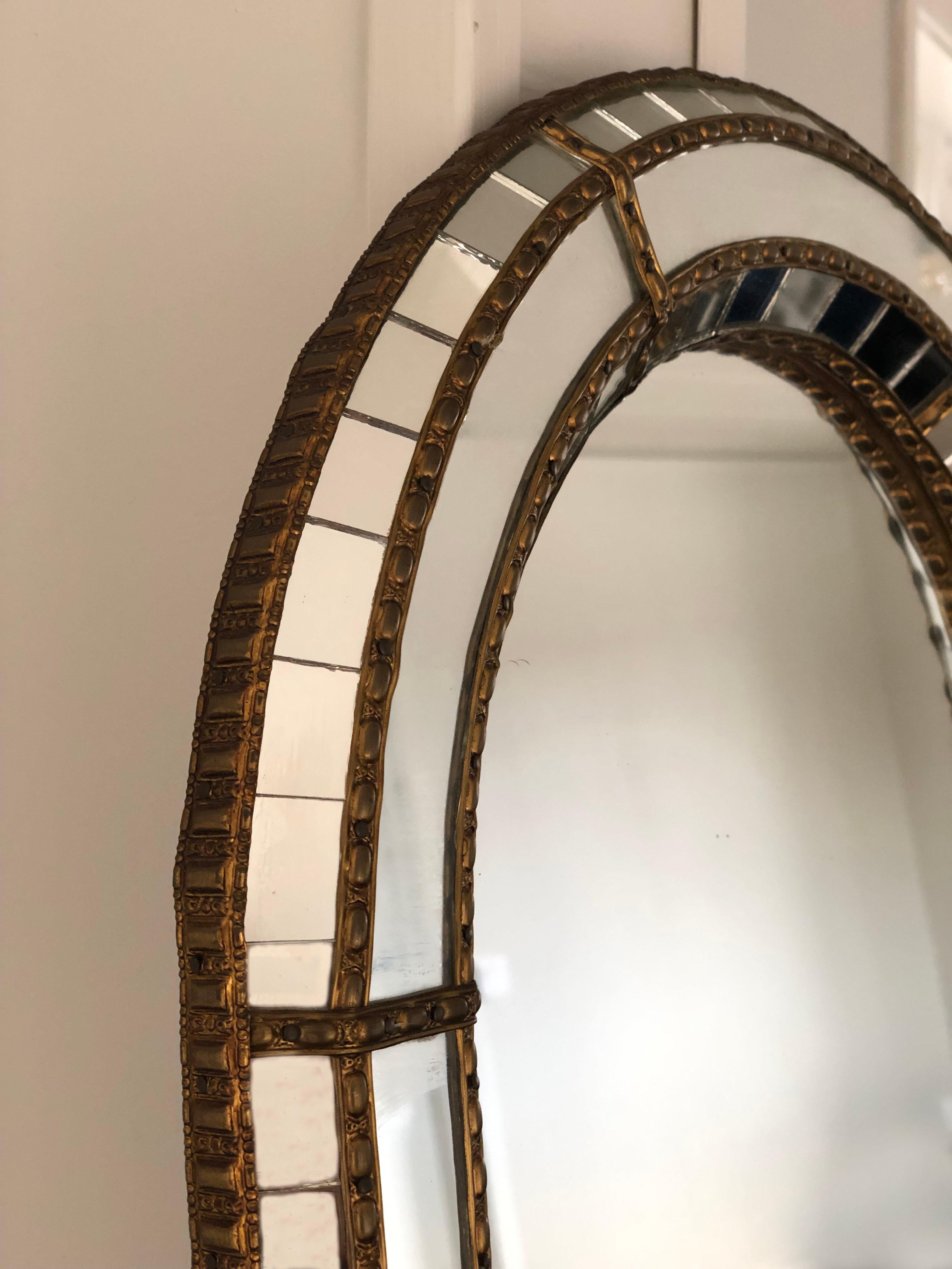 A beautiful Spanish mirrors with a Venetian glass frame with a brass golden strip. The frame is made with small crystals both on the outside and inside, and larger ones in the center line. The brass strip holds the mirror together.

Handmade mirror
