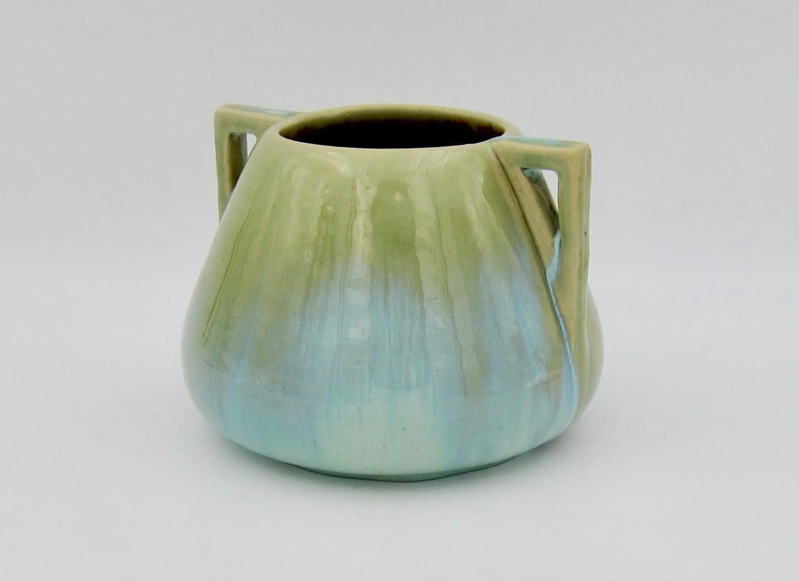 An early 20th century vase from the Arts & Crafts period by Fulper Pottery of Flemington, New Jersey. This art pottery vessel is decorated with a flambé glaze in shades of frothy green and greenish-golden brown.

The vessel is marked underfoot