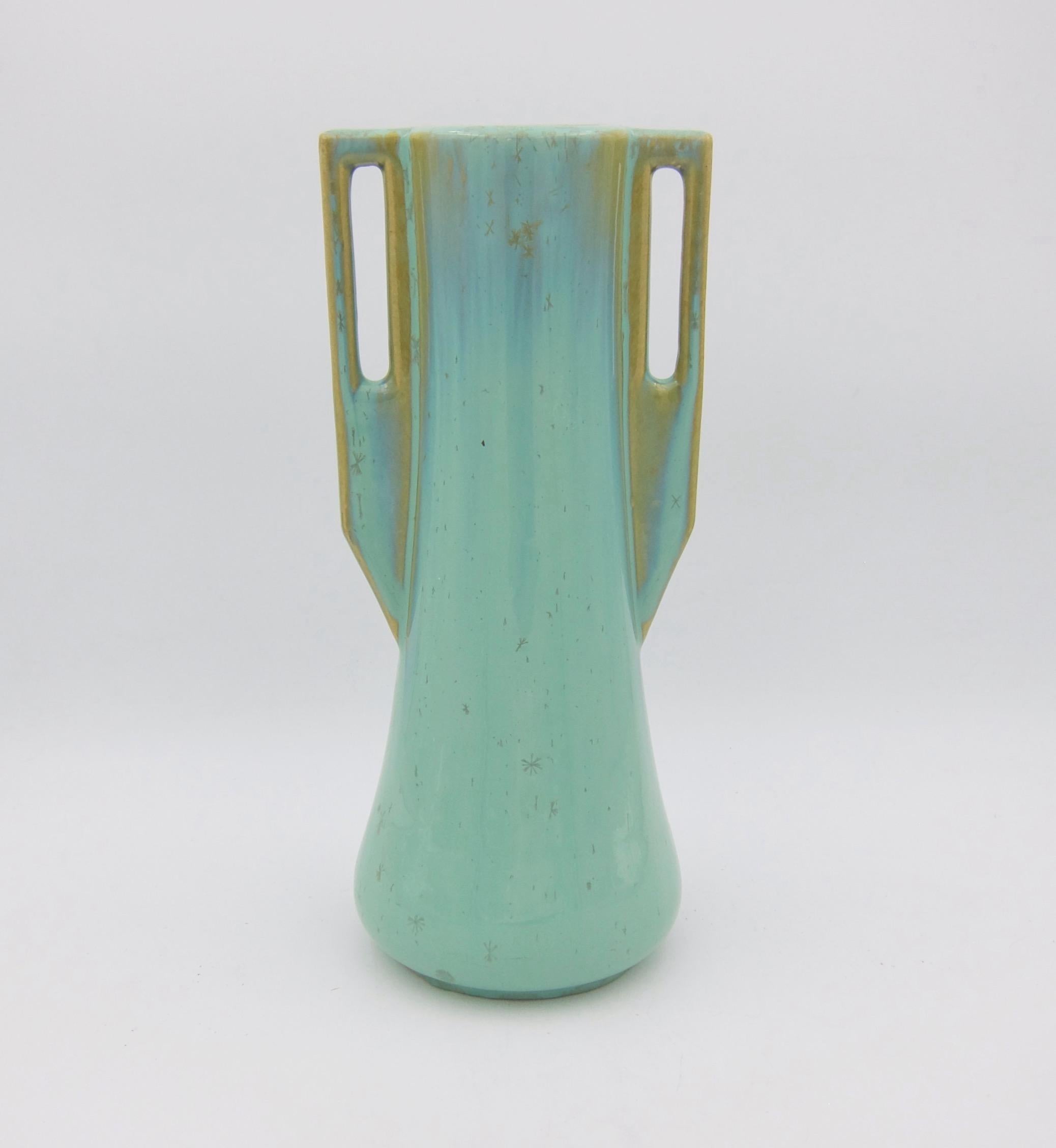 An early 20th century Arts & Crafts vase from Fulper Pottery of Flemington, New Jersey. This substantial piece of American art pottery is Fulper's form 27 featuring a tapering body and two squared buttressed handles. The vase is decorated with a