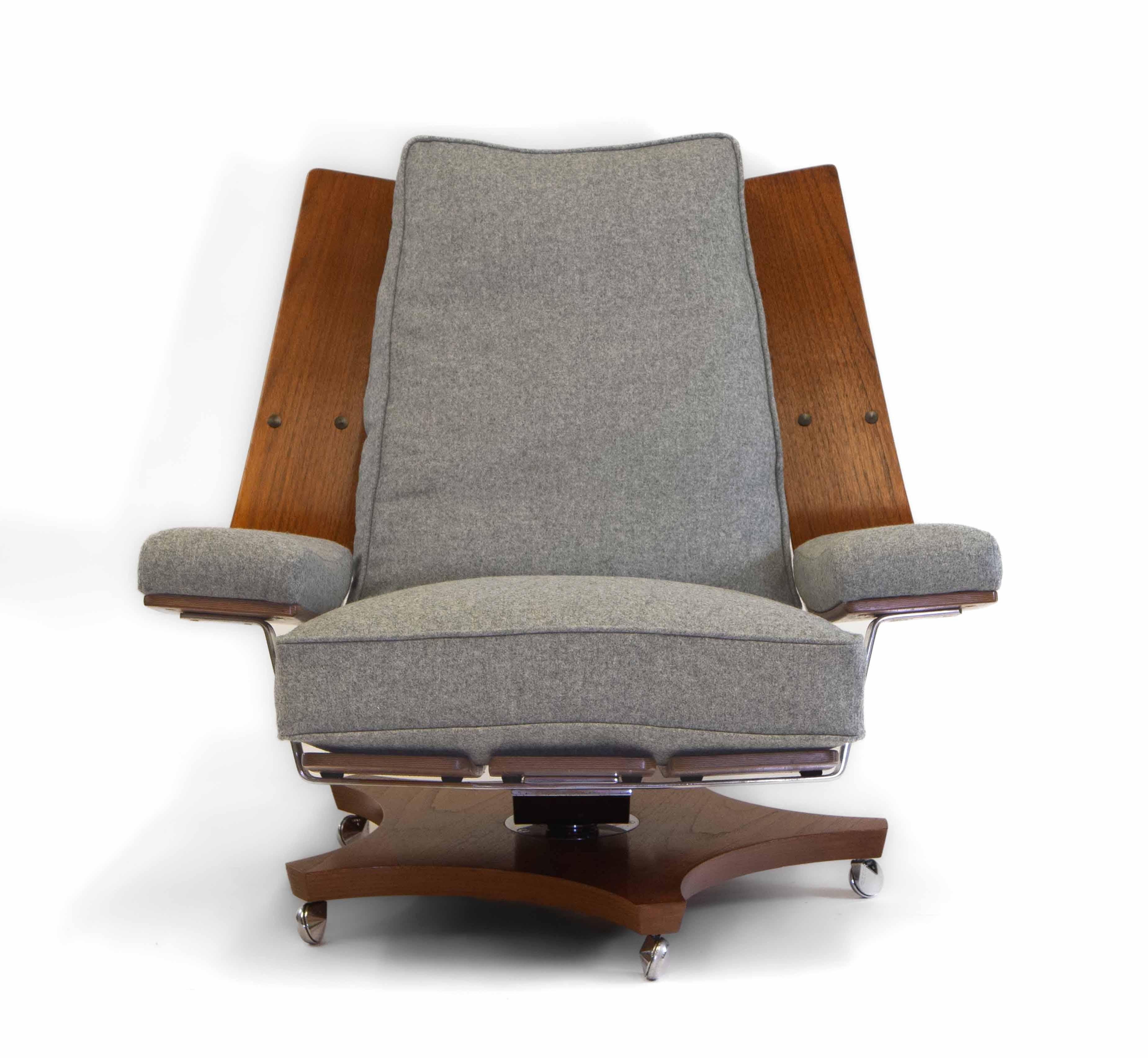 A superb iconic British statement chair - G-Plan “Housemaster” lounger armchair. circa 1970.

One of two available. 

Teak bent-ply design with oversized chrome plated brass T-back. The lounger's mechanism has light rocking motion and swivel