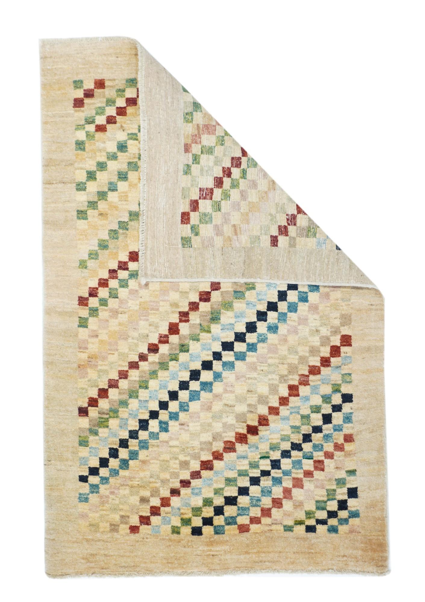 Vintage Gabbeh rug 3.1'' x 4.10''. A broad abrashed plain tan-beige border surrounds the field with its color diagonals composed of squares in shades of red, rust, black, teal, pale blue, straw and khaki. Abrashed squares and no brash, saturated