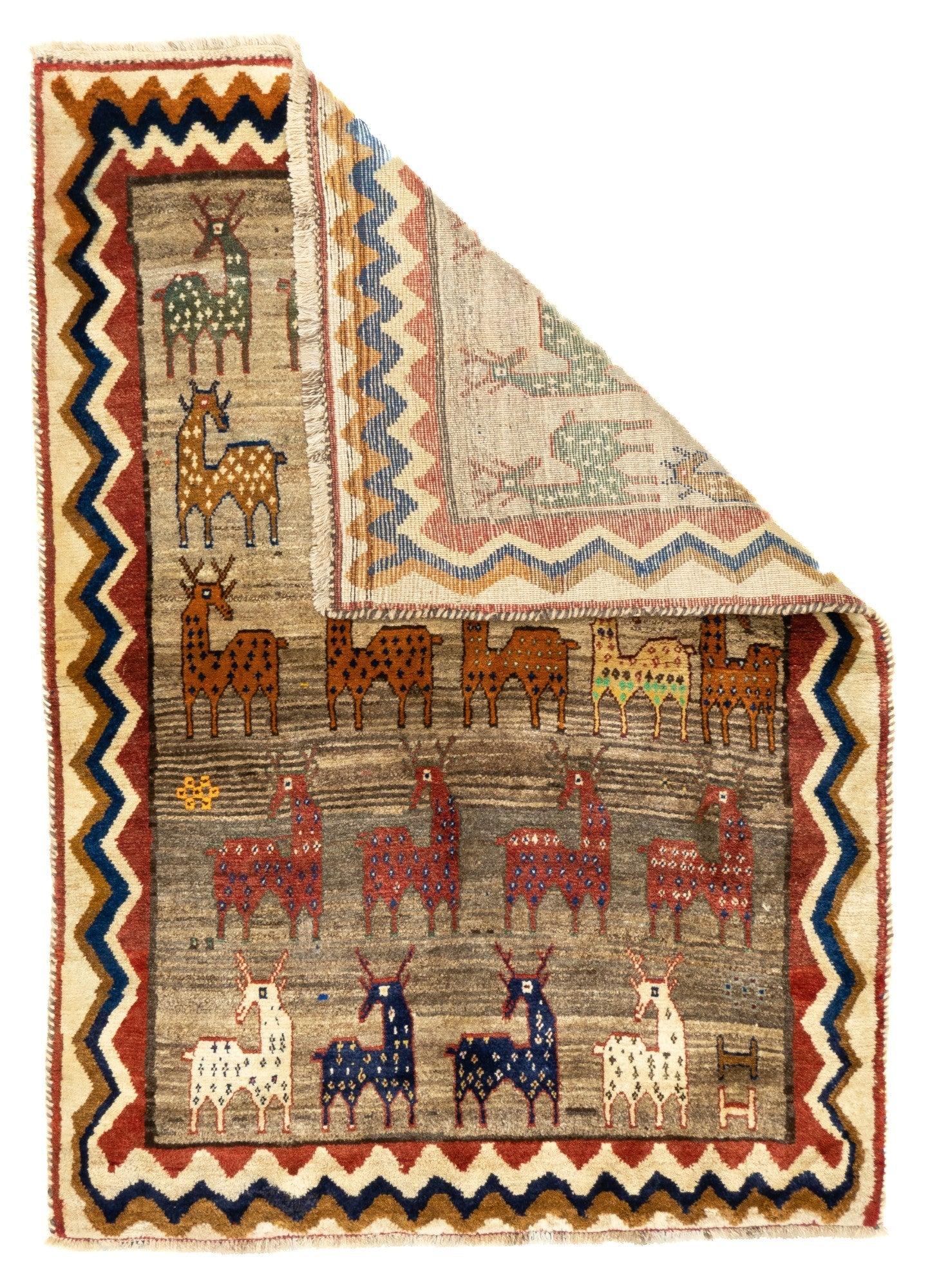 Vintage Gabbeh Rug 4'8'' x 6'5''. The striated abrashed natural light brown field presents five reversing rows of spotted quadrupeds, either deer (with antlers) or maybe short giraffes. Rust, red, navy and eggshell are among the detail tones.