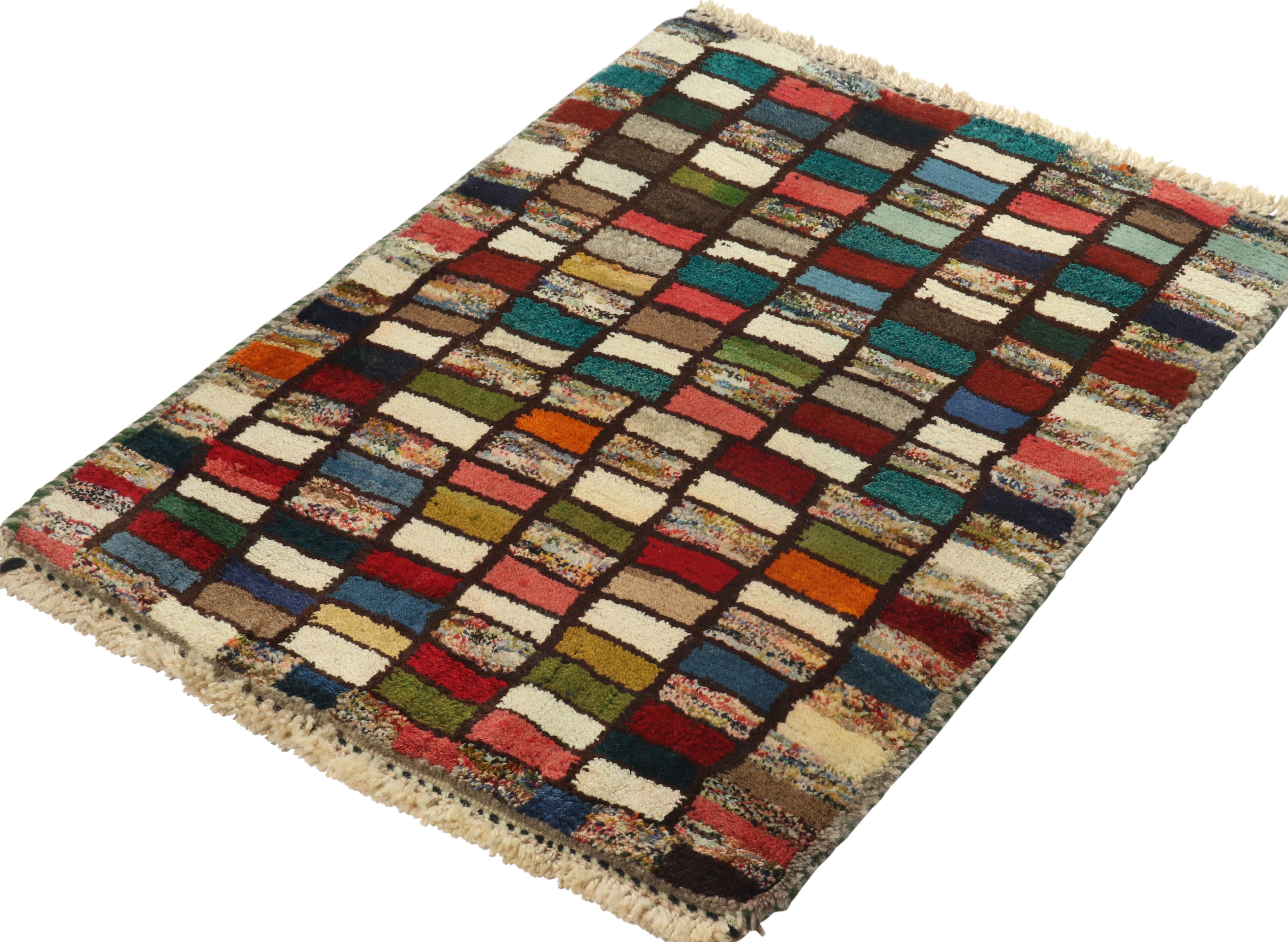 This vintage 2x3 Gabbeh Persian rug is from an exciting new curation of tribal rugs by Rug & Kilim. Hand-knotted in wool, it originates circa 1950-1960.

Further on the Design: 

This tribal provenance is one of the most primitive, and collectible