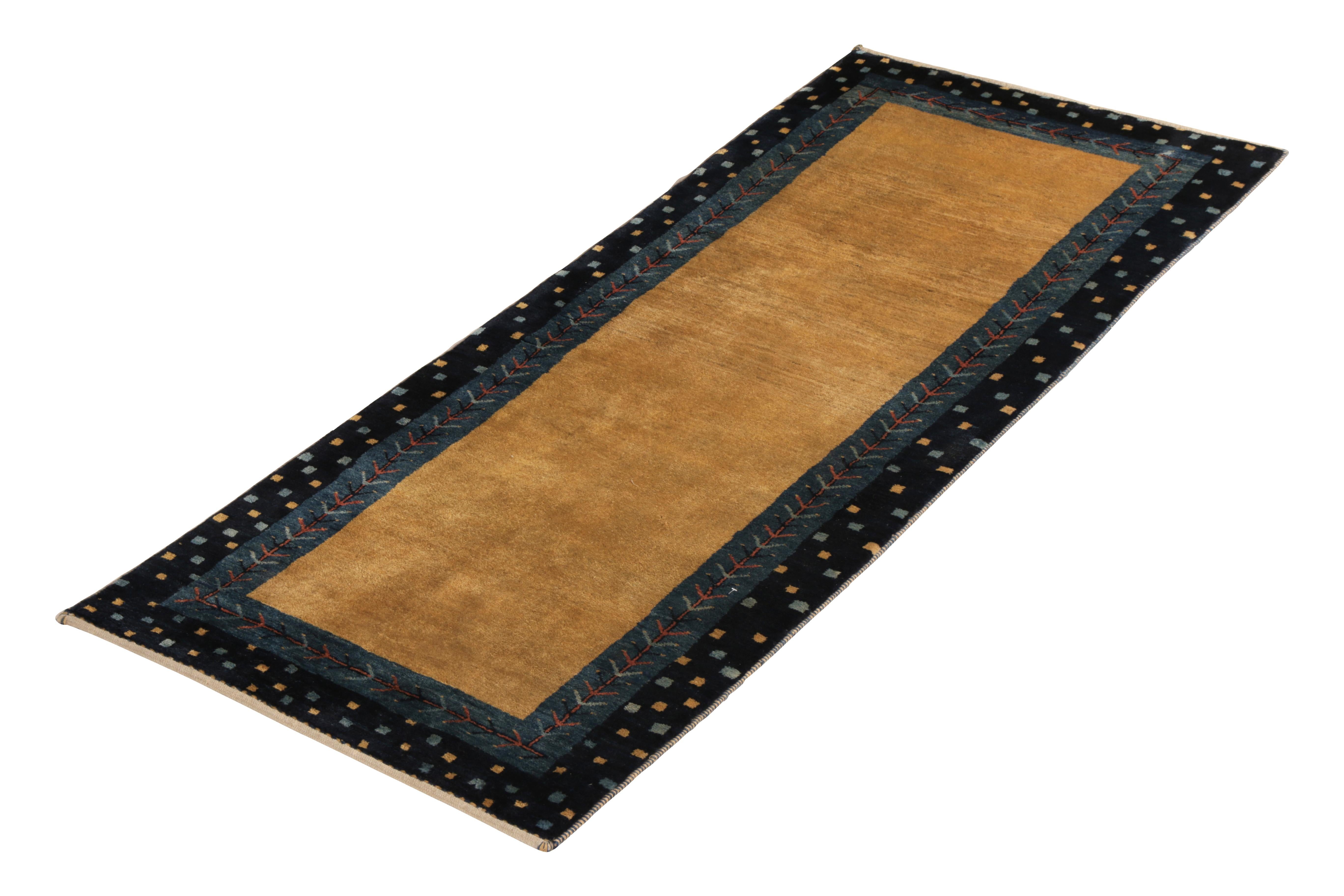 Hand knotted in wool originating from the Gabbeh tribal weavers made in 1985, this vintage Persian runner draws on the classic open-field rug and tribal border patterns of antique and vintage Gabbeh rug weavers, sporting a lush pile height and