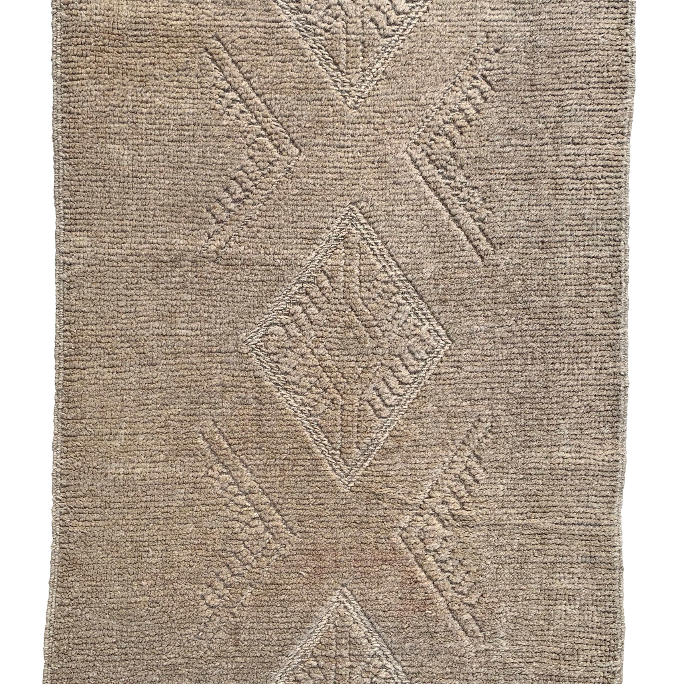 A wonderful 21st century Persian Gabbeh runner with a beautiful tone on tone woven pattern containing multiple diamonds running the length of the rug.