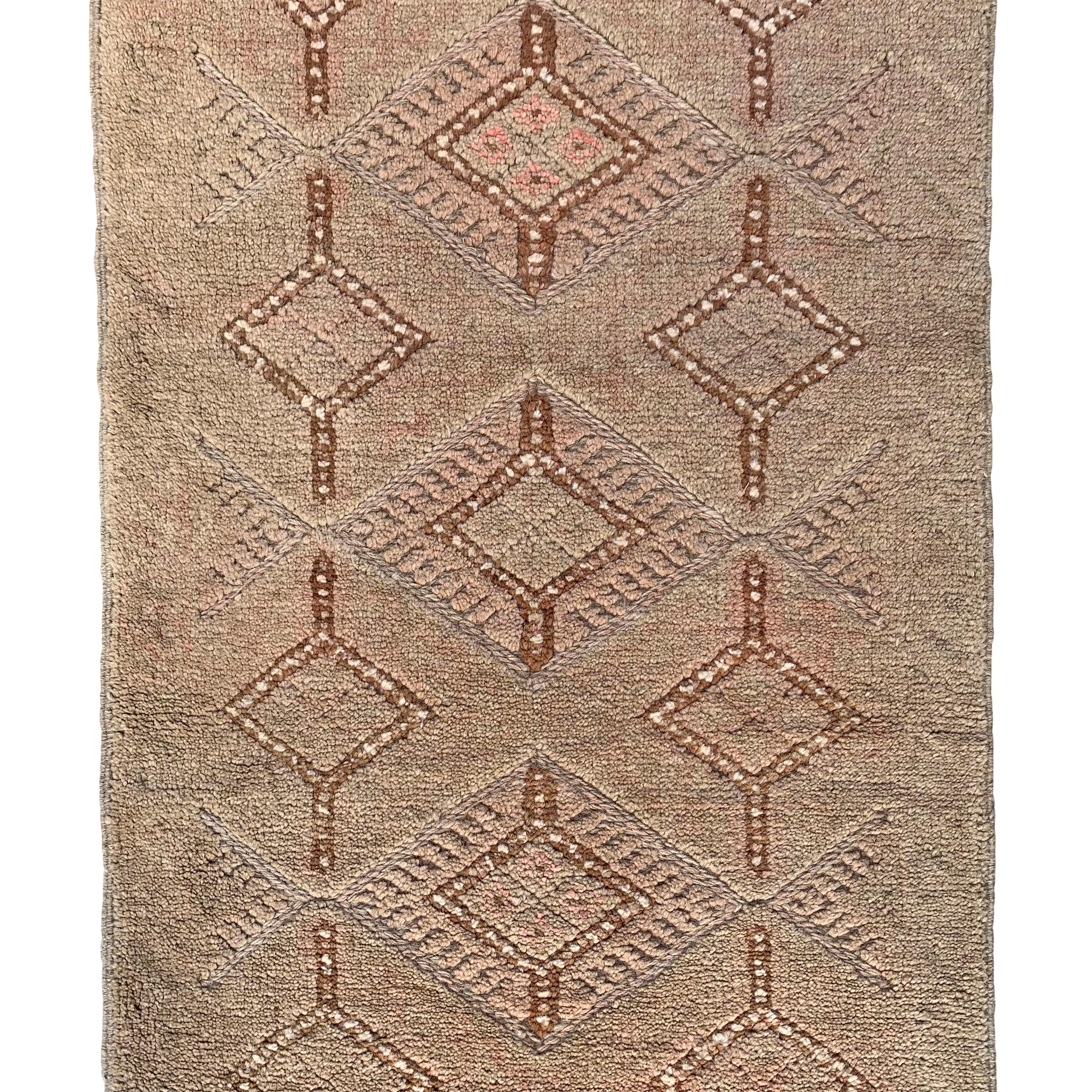 A wonderful vintage late 20th century Persian Gabbeh runner with a beautiful tone on tone woven pattern containing multiple diamonds running the length of the rug.