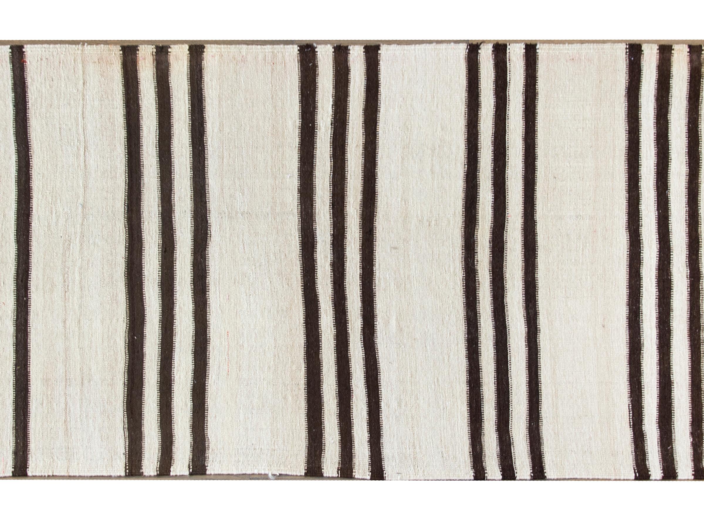 A wonderfully modern yet rustically chic vintage Persian Gabbeh runner woven in brown and natural wool colored stripes.