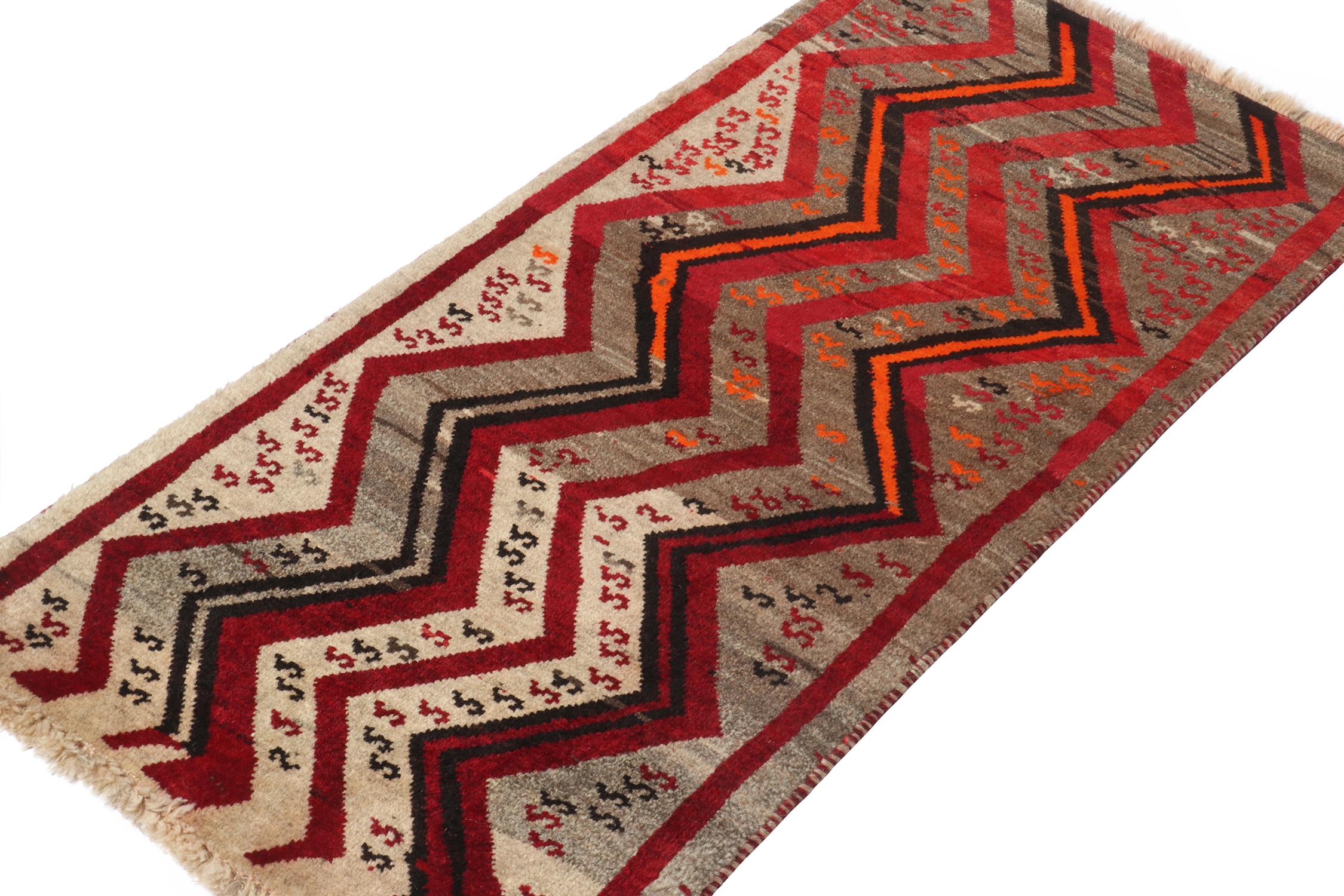 A vintage 2x4 Persian Gabbeh rug, from a grand entry to Rug & Kilim’s curation of rare tribal pieces. Hand-knotted in wool circa 1950-1960. 

On the Design: 

This mid-century piece features chevrons and motifs in bold red, orange and black atop