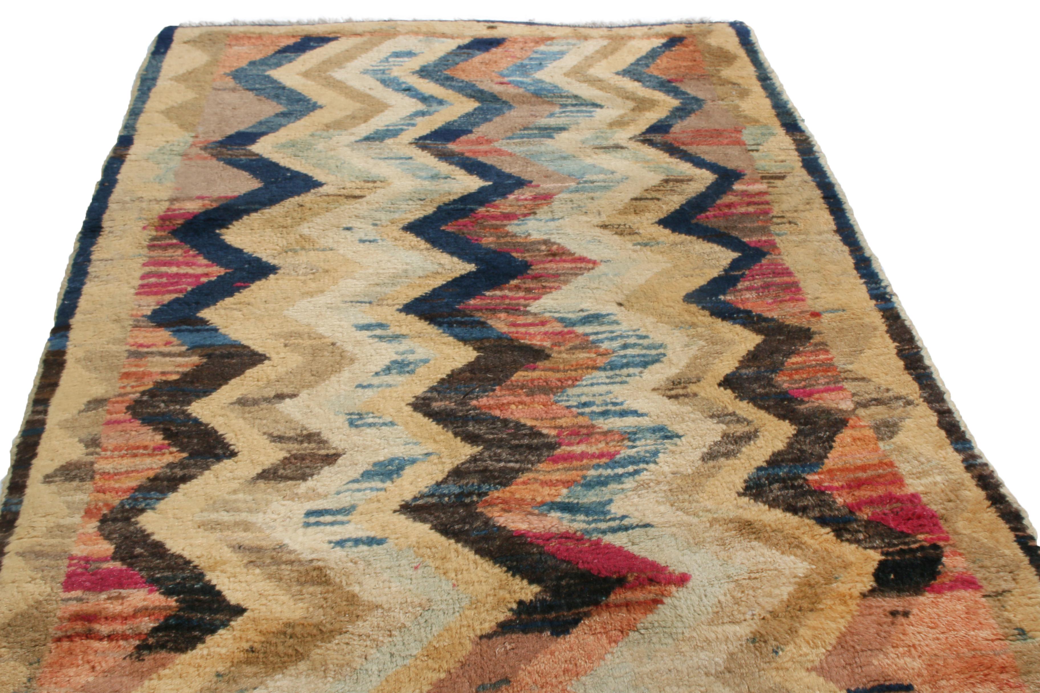 Originating from Persia in 1940, this vintage transitional Gabbeh wool rug features an uncommon series of colourways in a tribal chevron pattern. Hand knotted in high quality, very silky and luminous wool, each Gabbeh piece has a sense of