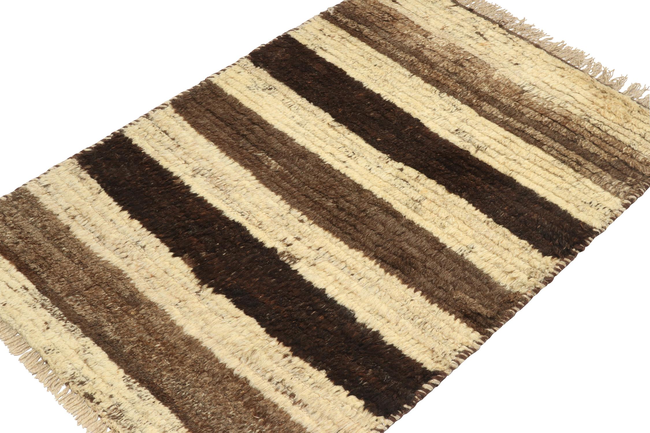 A vintage 2x4 Persian Gabbeh rug, making a grand entry to Rug & Kilim’s curation of rare tribal pieces. Hand-knotted in wool, originating circa 1950-1960. 

Further On the Design: 

This piece features a gorgeous play of beige and brown stripes,