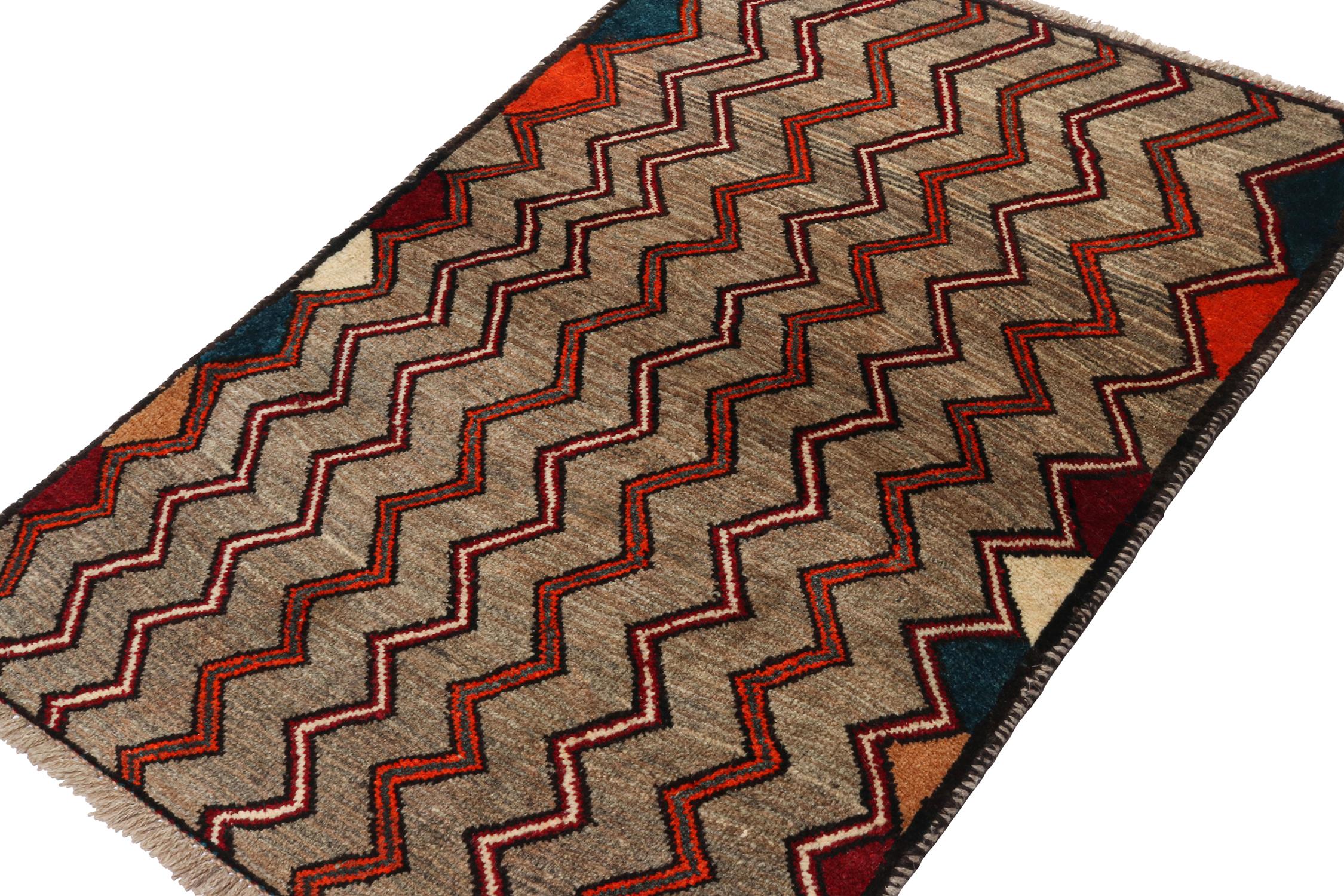 A vintage 3x5 Persian Gabbeh rug in the latest entries to Rug & Kilim’s curation of rare tribal pieces. Hand-knotted in wool circa 1950-1960.

On the Design:

This pattern enjoys chevrons in vibrant orange, red, and white hues on a soft