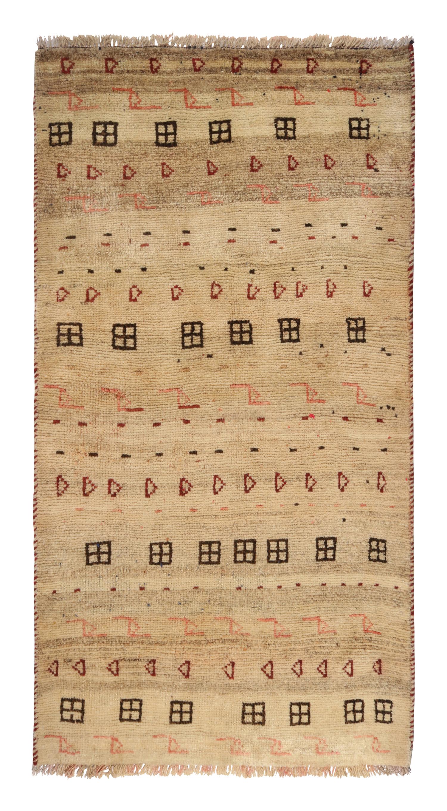 This vintage 3x5 Gabbeh Persian rug is from the latest entries in Rug & Kilim’s rare tribal curations. Hand-knotted in wool circa 1950-1960.

On the Design: 
This tribal provenance is one of the most primitive, and collectible shabby-chic styles
