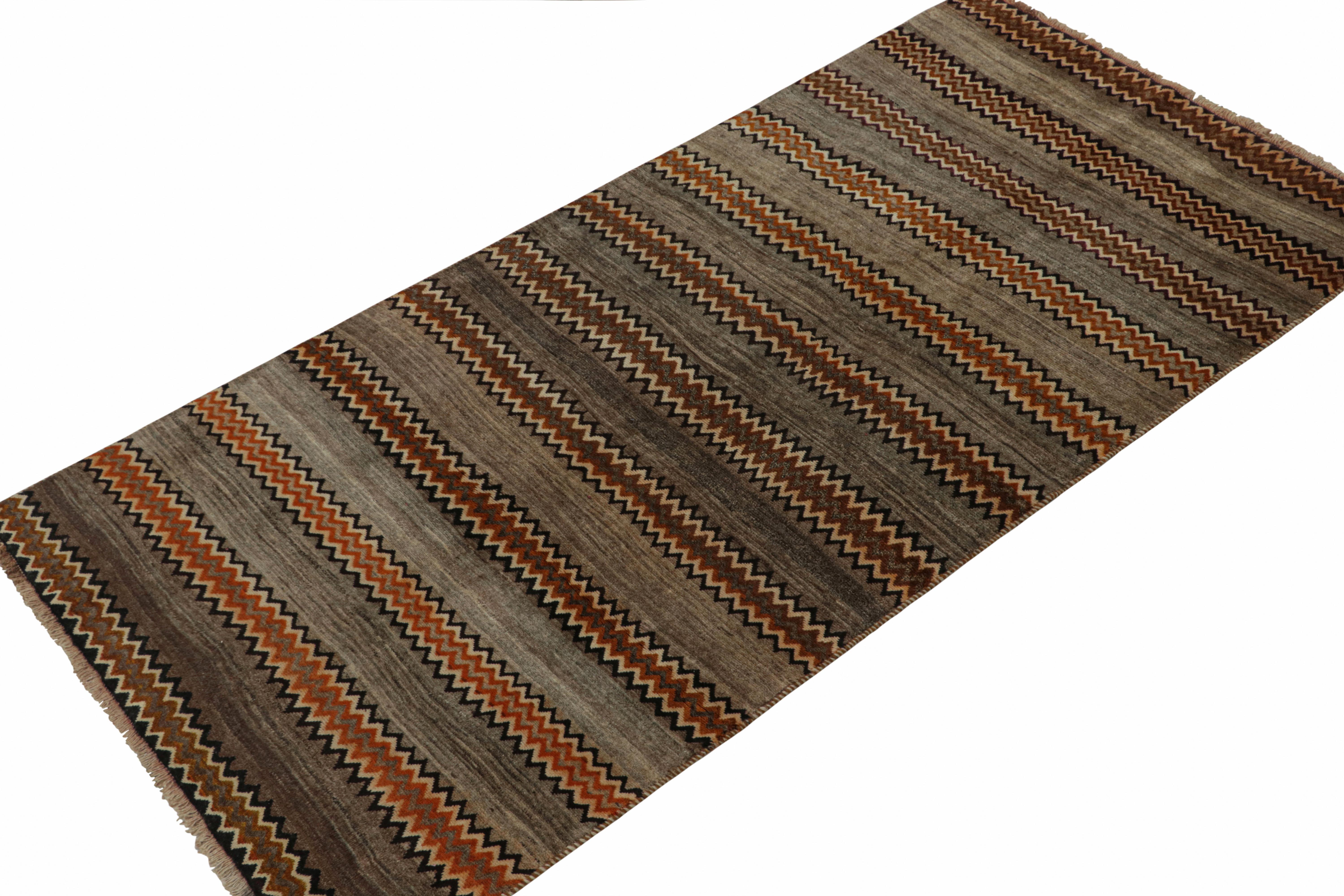 A vintage 5x10 Persian Gabbeh rug in the latest entries to Rug & Kilim’s curation of rare tribal pieces. Hand-knotted in wool circa 1950-1960.

On the Design:

This gray rug enjoys stripes and chevron patterns alternating in beige-brown and