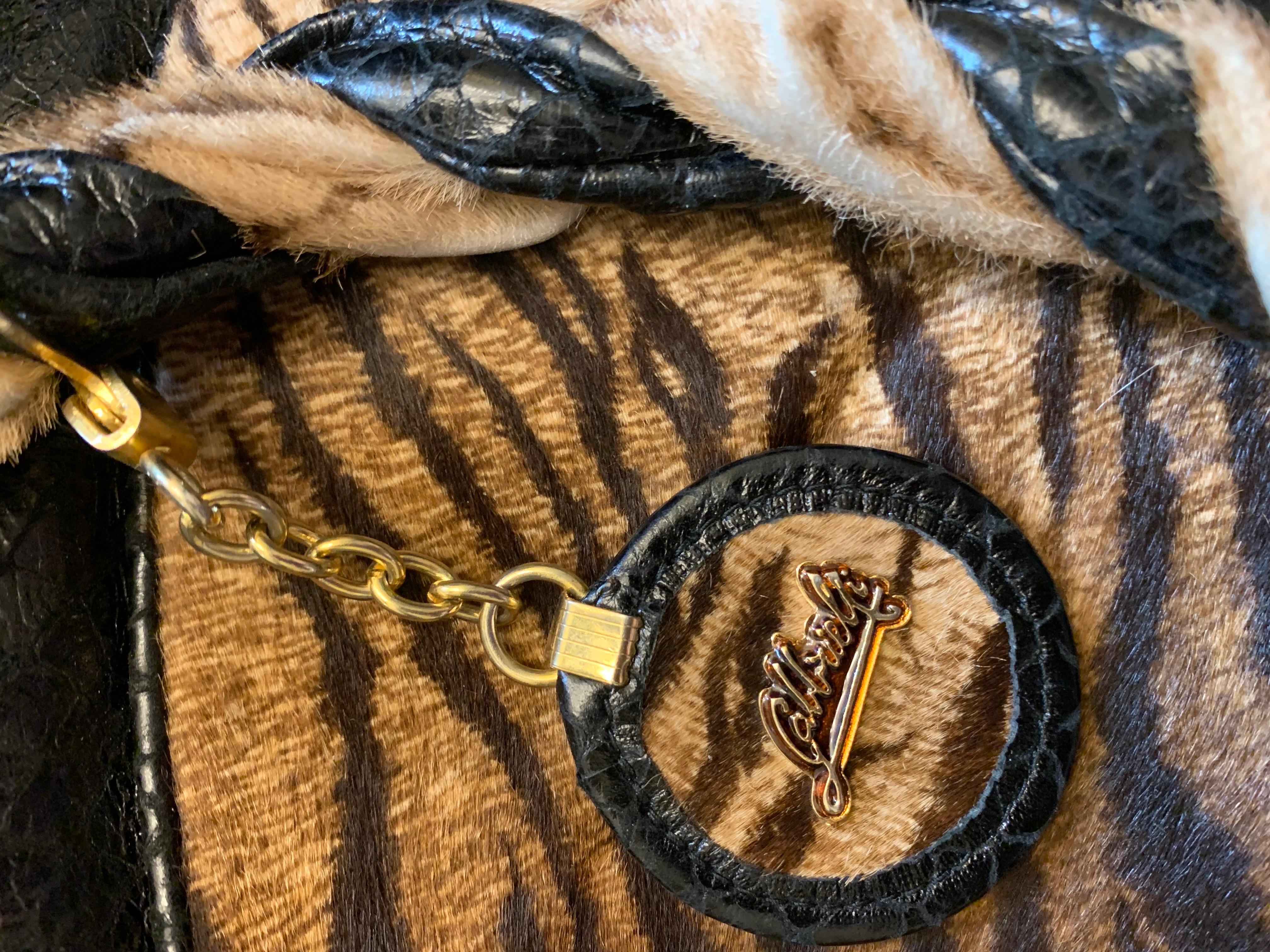 A vintage 1990s canoe shaped handbag by Firenze Italian maker Gabbrielli. The bag is a mix of brown zebra print pony hair leather and black embossed leather that looks like real snakeskin. The handle hardware is spectacular. Heavy with gold trim.