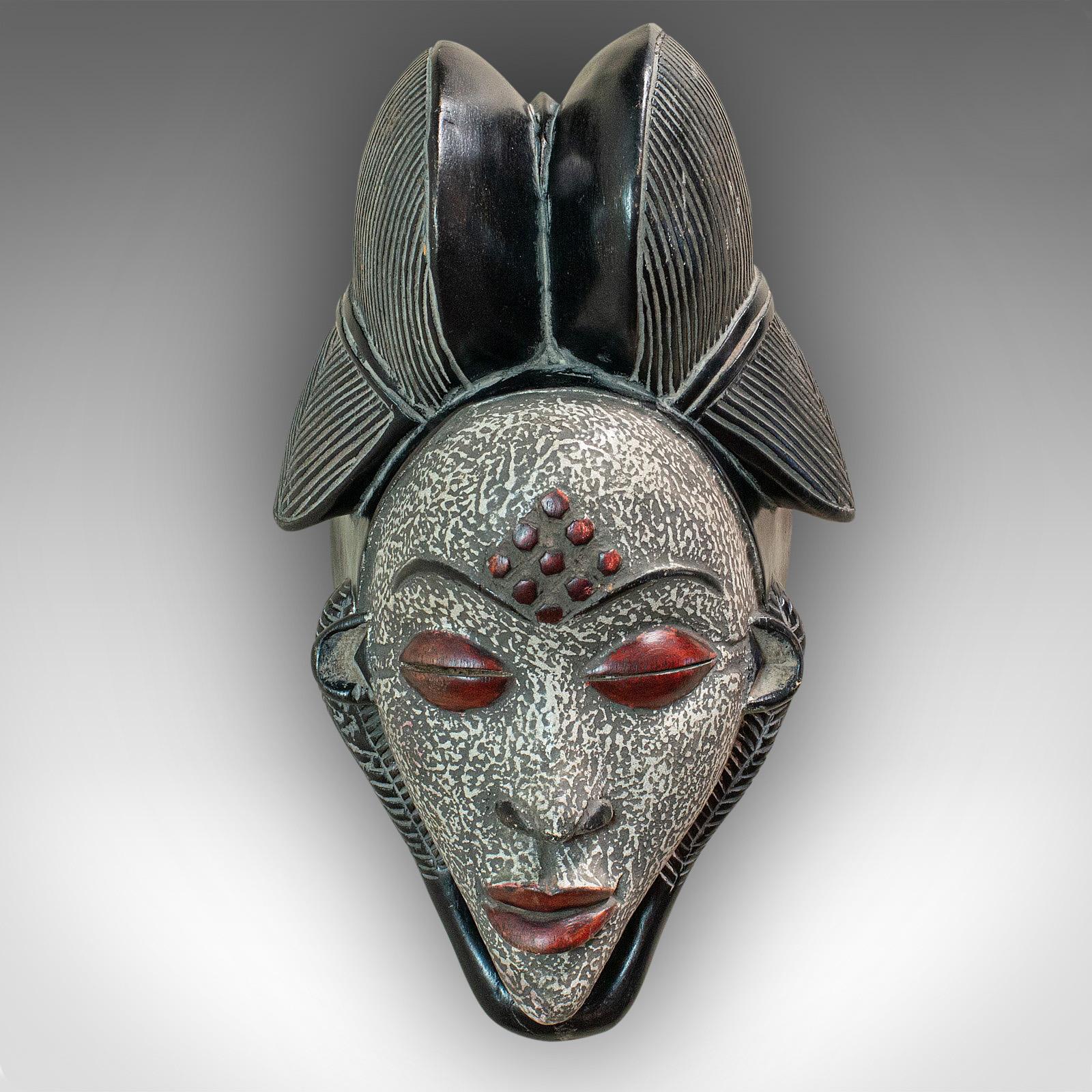 This is a vintage Gabonese Punu mask. An African, tropical hardwood decorative tribal mask, dating to the 20th century, circa 1970.

Fascinating detail and visual appeal
Displays a desirable aged patina
Carved tropical hardwood in good