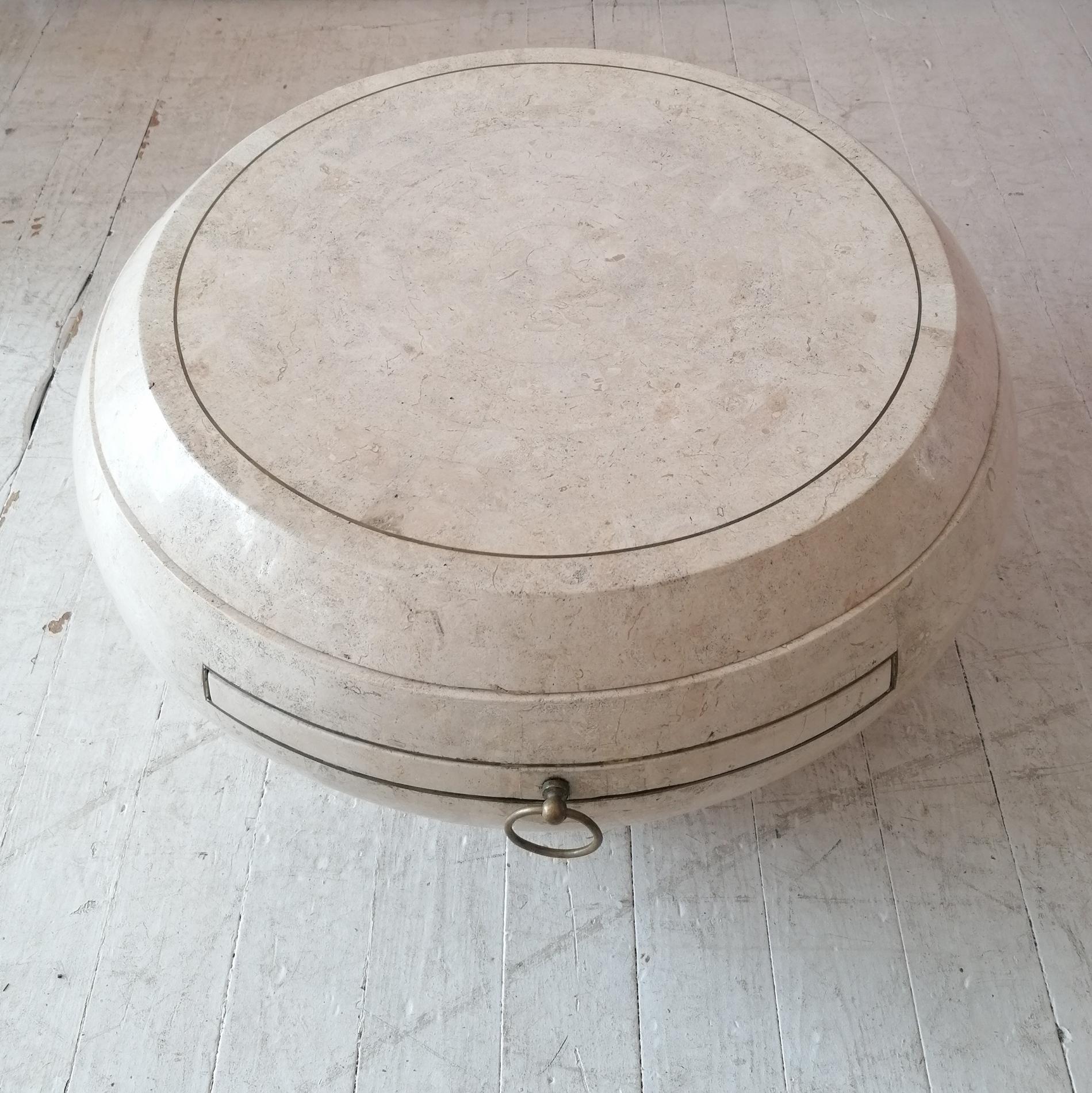 A rare Gabriella Crespi style swivel top coffee table with slide-out level . 
It has a tessellated stone veneer applied over wood, with brass ring pull handles, and inset brass trims. By Maitland Smith (label is missing), USA