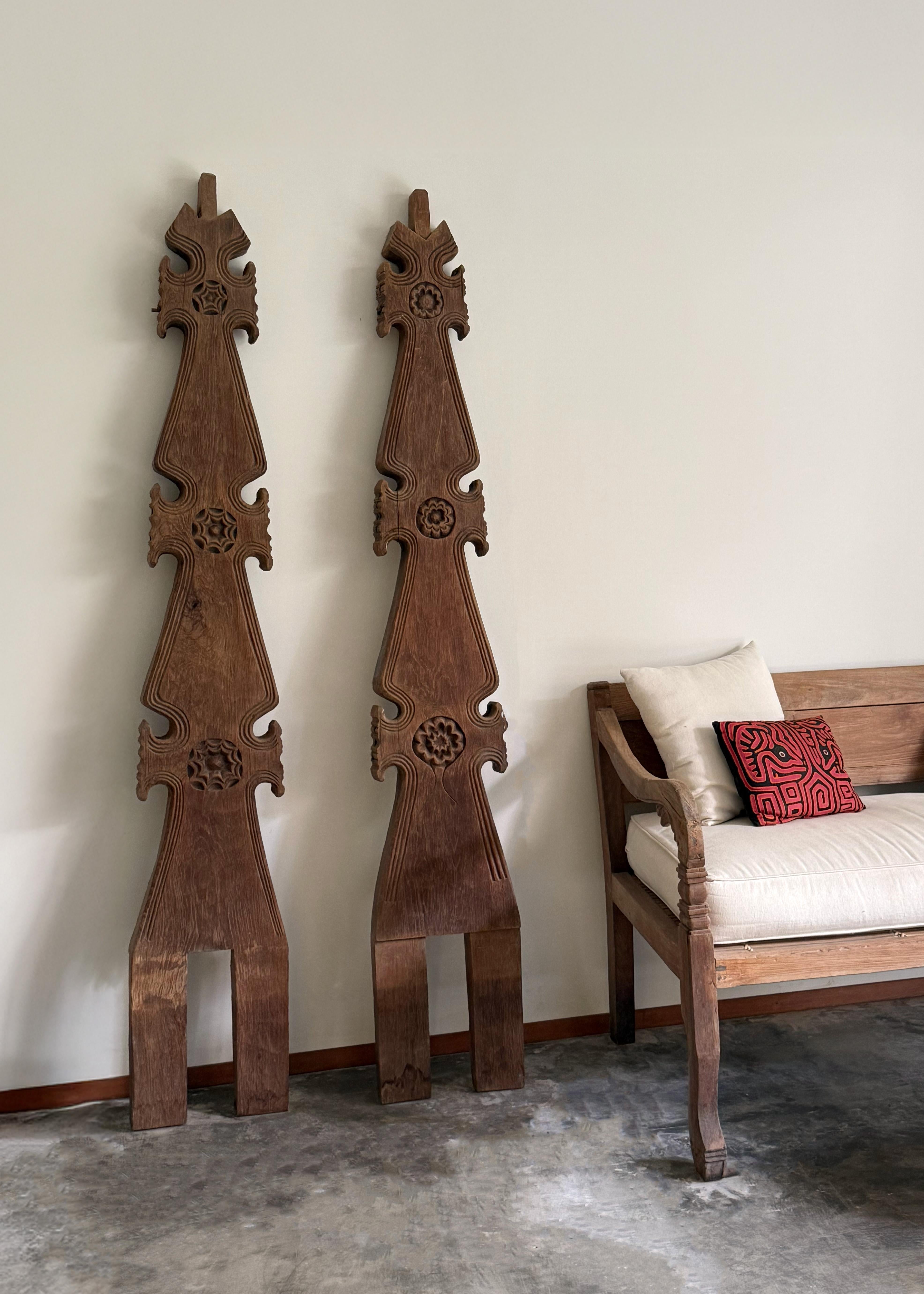 This striking set of vintage roof ornaments originates from a traditional Rumah Gadang house of the Minangkabau people in West Sumatra, Indonesia. Crafted from solid, timeworn hardwood, each piece is richly adorned with intricate floral