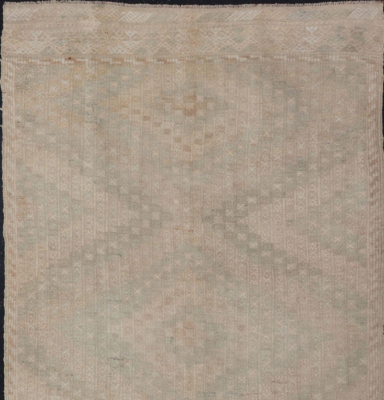 Vintage Gallery Turkish Embroidered Rug with Geometric Design in Soft Tones.
Embroidered vintage flat weave gallery rug from Turkey in shades of tan, taupe, green, cream and neutrals with geometric pattern, / rug EN-176475, country of origin /
