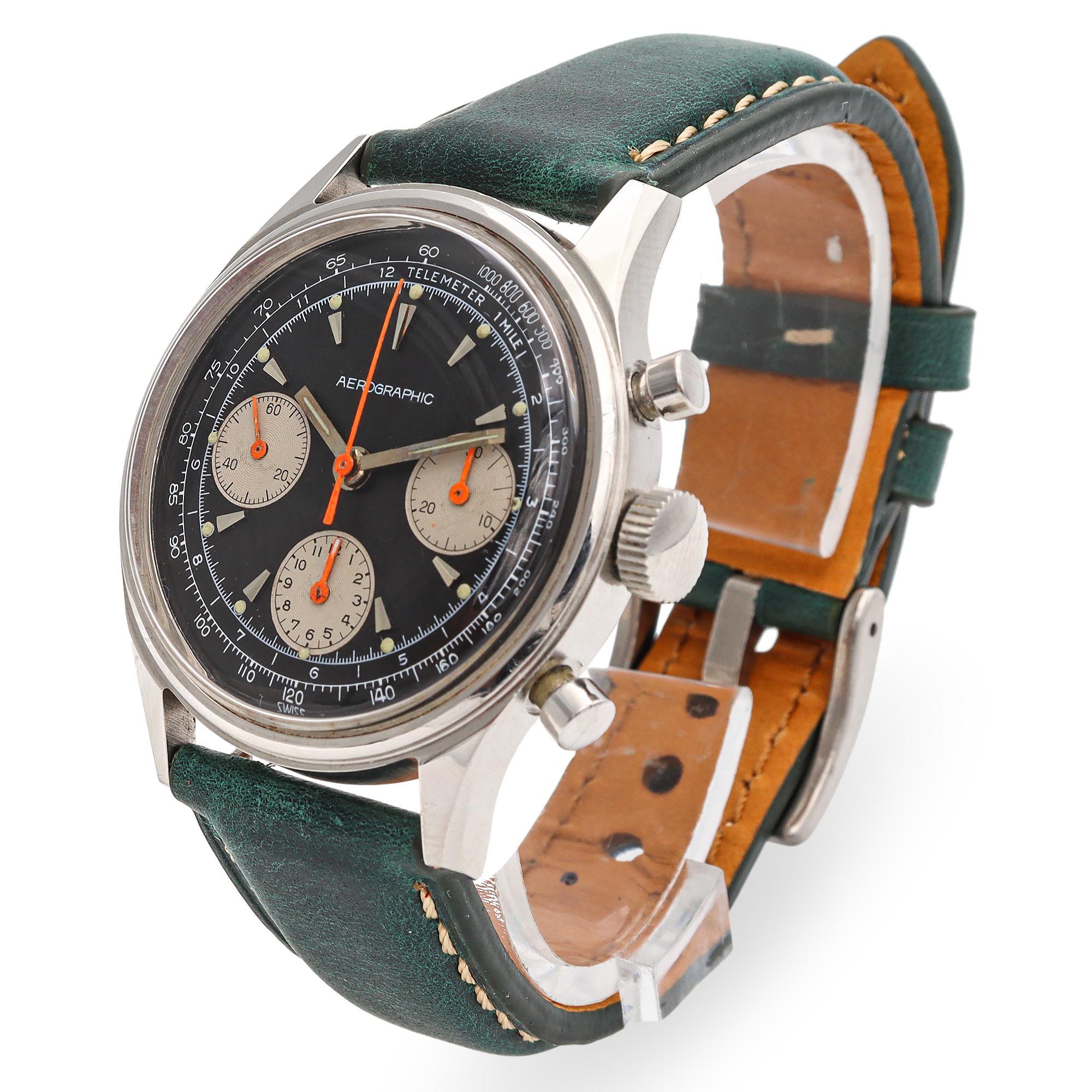 This Aerographic chronograph is a striking timepiece that blends vintage-inspired design with modern craftsmanship. Featuring a sleek black dial accented by three contrasting silver subdials, it offers precise chronograph functionality. The bold