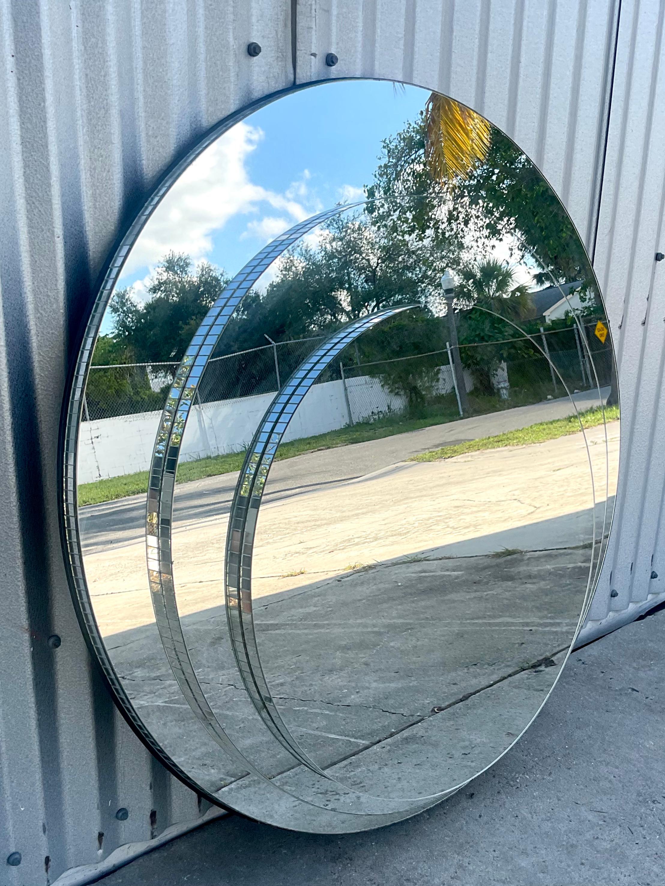 Striking vintage tri ring mirror. Beautiful stacked ring design with mirror tile trim. Marked on the back. Acquired from a Palm Beach estate.