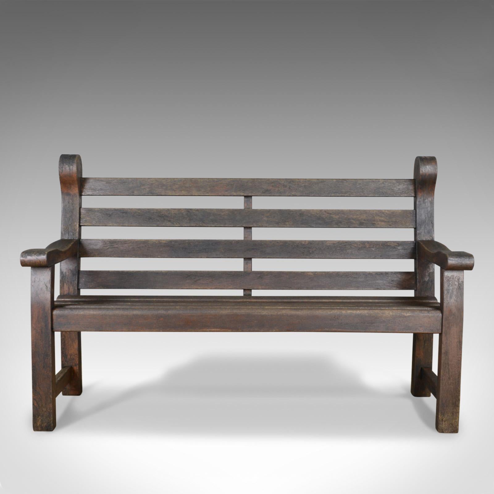 This is a vintage garden bench, an English, hardwood seat dating to the late 20th century seating three or four.

Classic English, slatted design
Handmade in quality hardwood
Pleasingly weathered with a desirable aged patina

Broad four plank