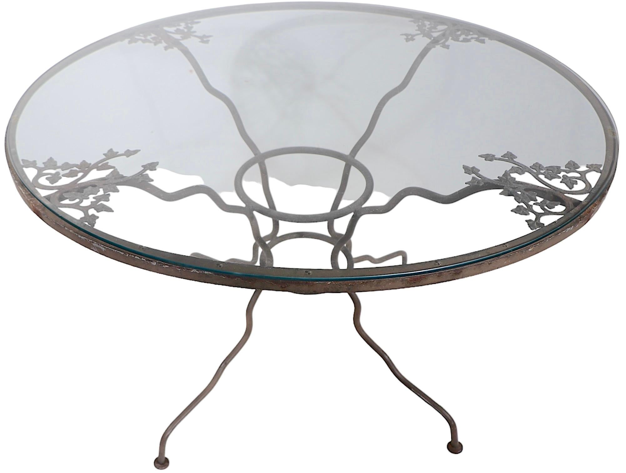 Very chic vintage garden cafe scale dining table with unusual squiggly shaped legs and decorative cast foliate trim. The table is structurally sound and sturdy, we love the somewhat distressed finish it is currently in, but also offer custom powder