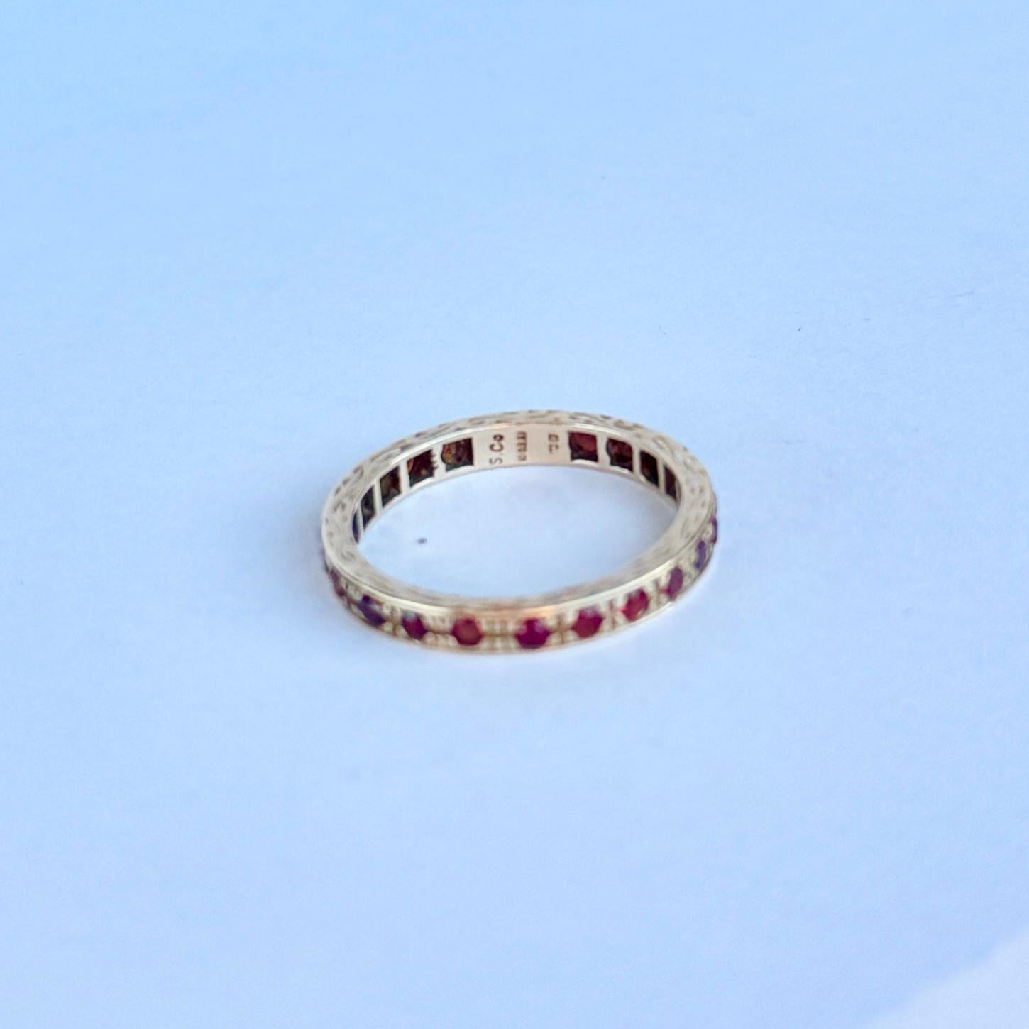 This stunning 9 carat gold band holds a total of 23 garnets. Each stone is a deep red colour but has a bright red glow in the light and measures 4pts. Fully hallmarked London 1970. 

Ring Size: O 1/2 or 7 1/2
Band Width: 2.5mm 

Weight: 2.1g