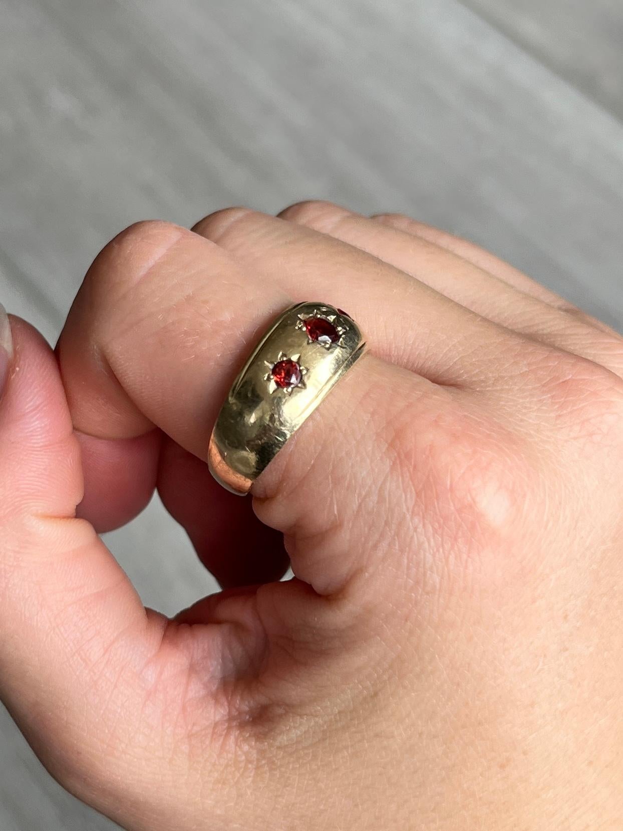 The garnet stones in this ring are deep red in colour and when they hit the sunlight they glow bright red. They are set in star settings. 

Ring Size: T or 9 1/2 
Band Width: 9.5mm 

Weight: 4.3g