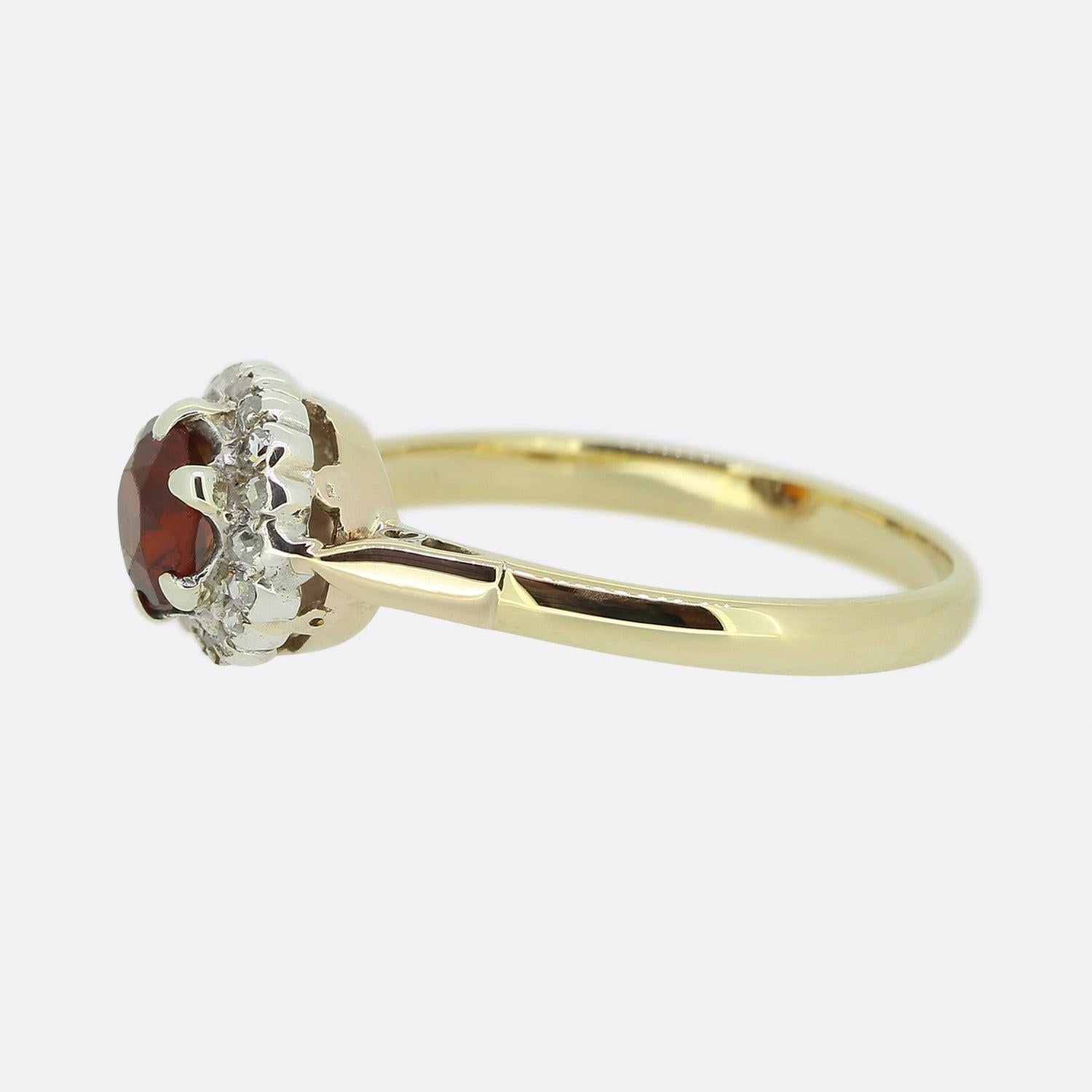 Here we have a lovely vintage garnet and diamond cluster ring. A six clawed platinum setting plays host to a round faceted garnet possessing a rich orange colour tone. This principle stone is then surrounded by a single row of rose cut diamonds