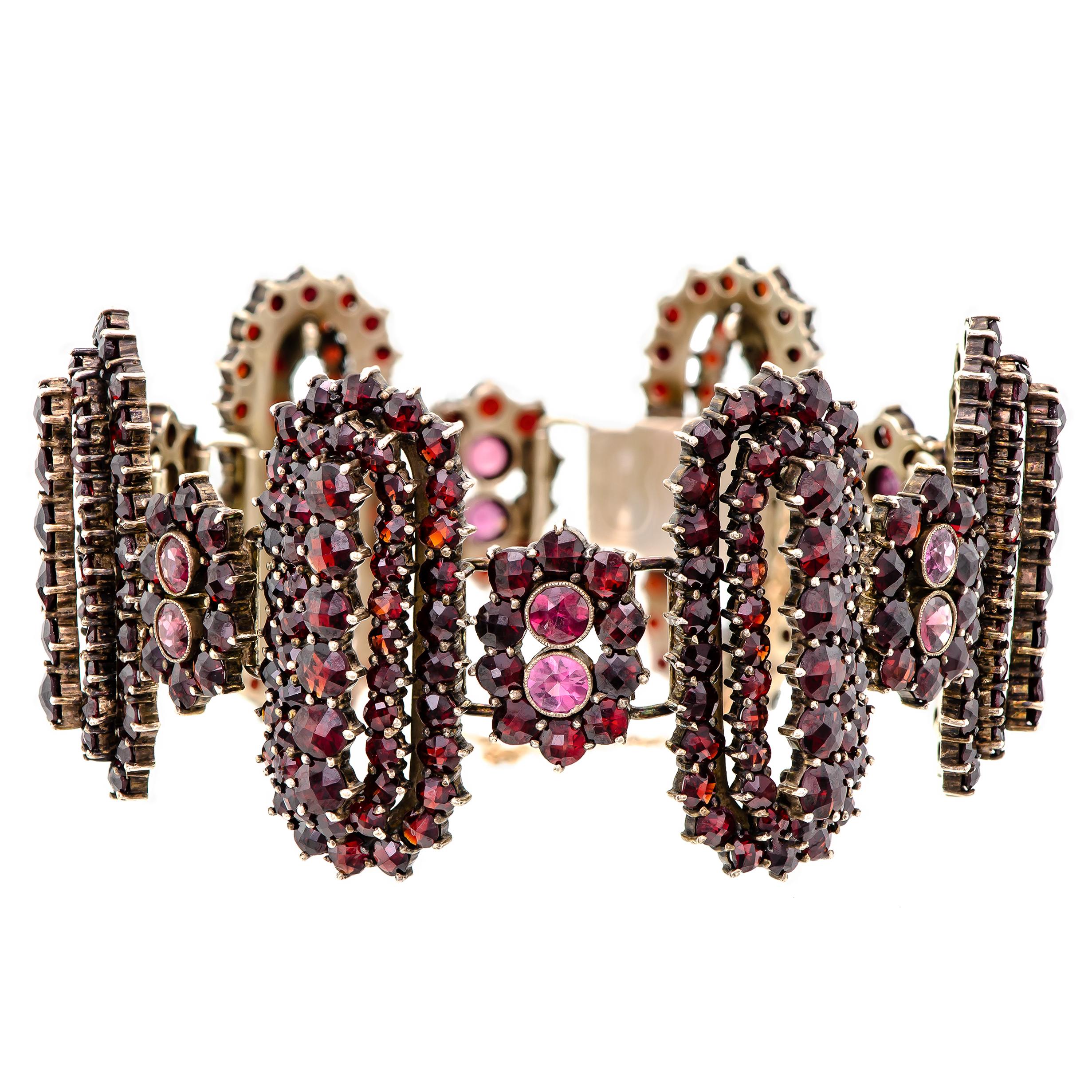 Magnificent vintage garnet and gilt-hinged wide flexible bracelet - set with numerous dazzling rose cut garnets into a repeated alternating hinged pattern of small and large lozenge-shaped sections. The garnets are deep in color and set in gilt or