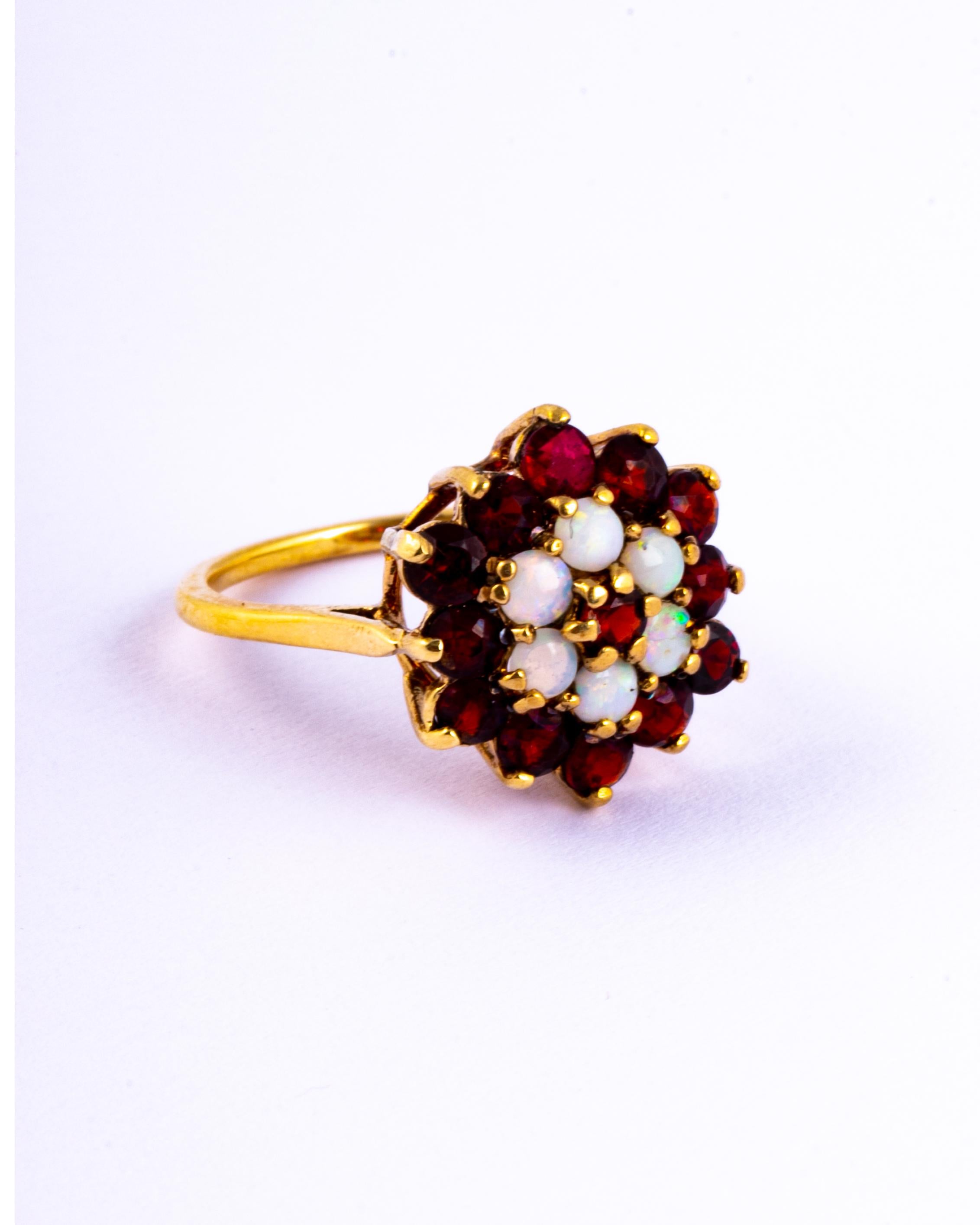 This striking ring holds round cut garnets totalling approx 65pts and 6 shimmering opals. All the stones sit in 9carat gold claws. Made in London, England. 

Ring Size: L 1/2 or 6 
Cluster Diameter: 15mm
Height Off Finger: 8mm

Weight: 2.79g