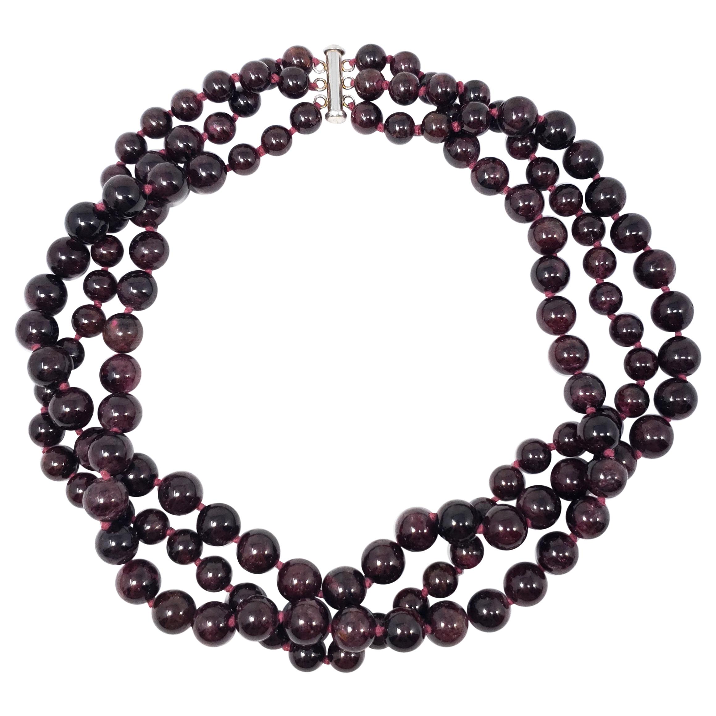 Three strands of lavish garnet beads on a knotted string necklace, fastened with a sterling silver clasp. An exquisite necklace for any occasion!

Marks / hallmarks / etc: 925