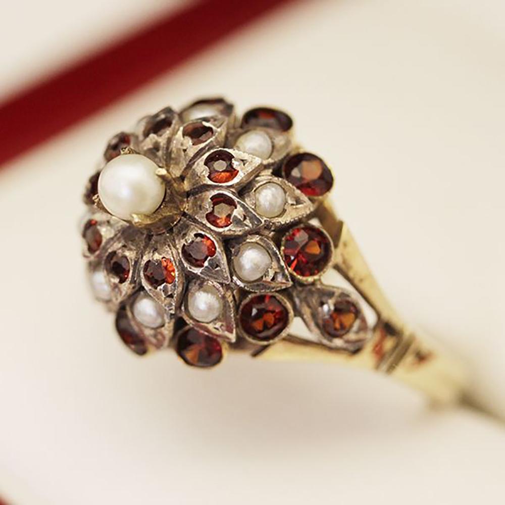 Stunning Antique Pearl and Garnet Princess Cluster Ring, Cocktail ring, Handmade 14ct yellow Gold and Silver (acid tested) 33 stone Pearl and Garnet Princess cluster ring.
Cultured Pearl yellow gold 4 claw set surrounded by 10 round Garnets grain