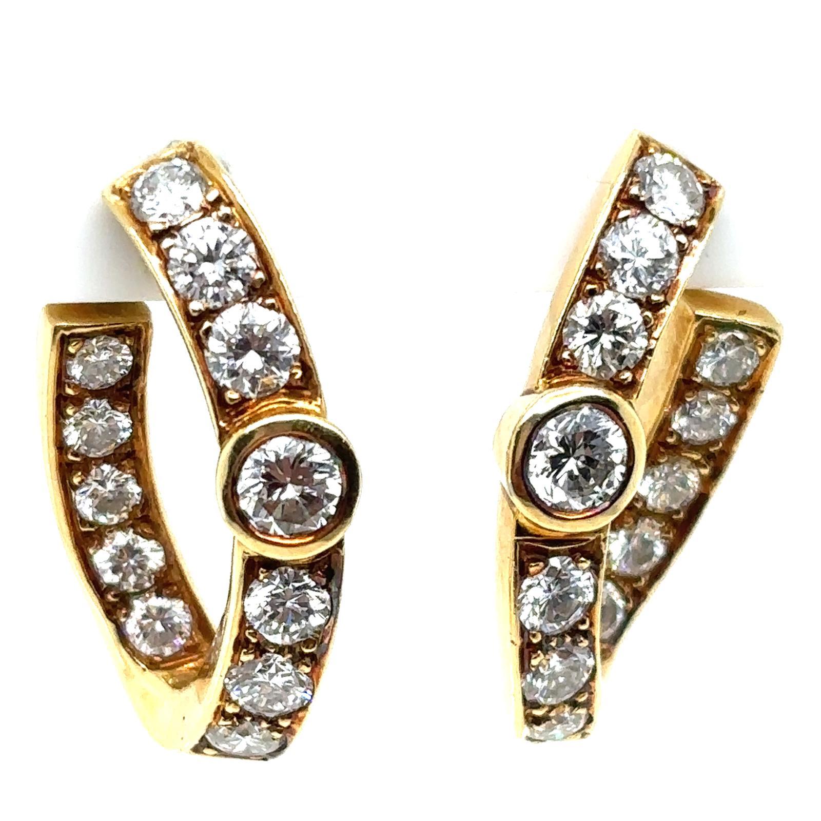 A pair of vintage Garrard & Co 18 karat yellow gold diamond hoop earrings

With twenty four round brilliant cut diamonds totalling 2ct approximately assessed as F/G colour, VS2/SI1 clarity, grain set with diamonds along the outer curve with an