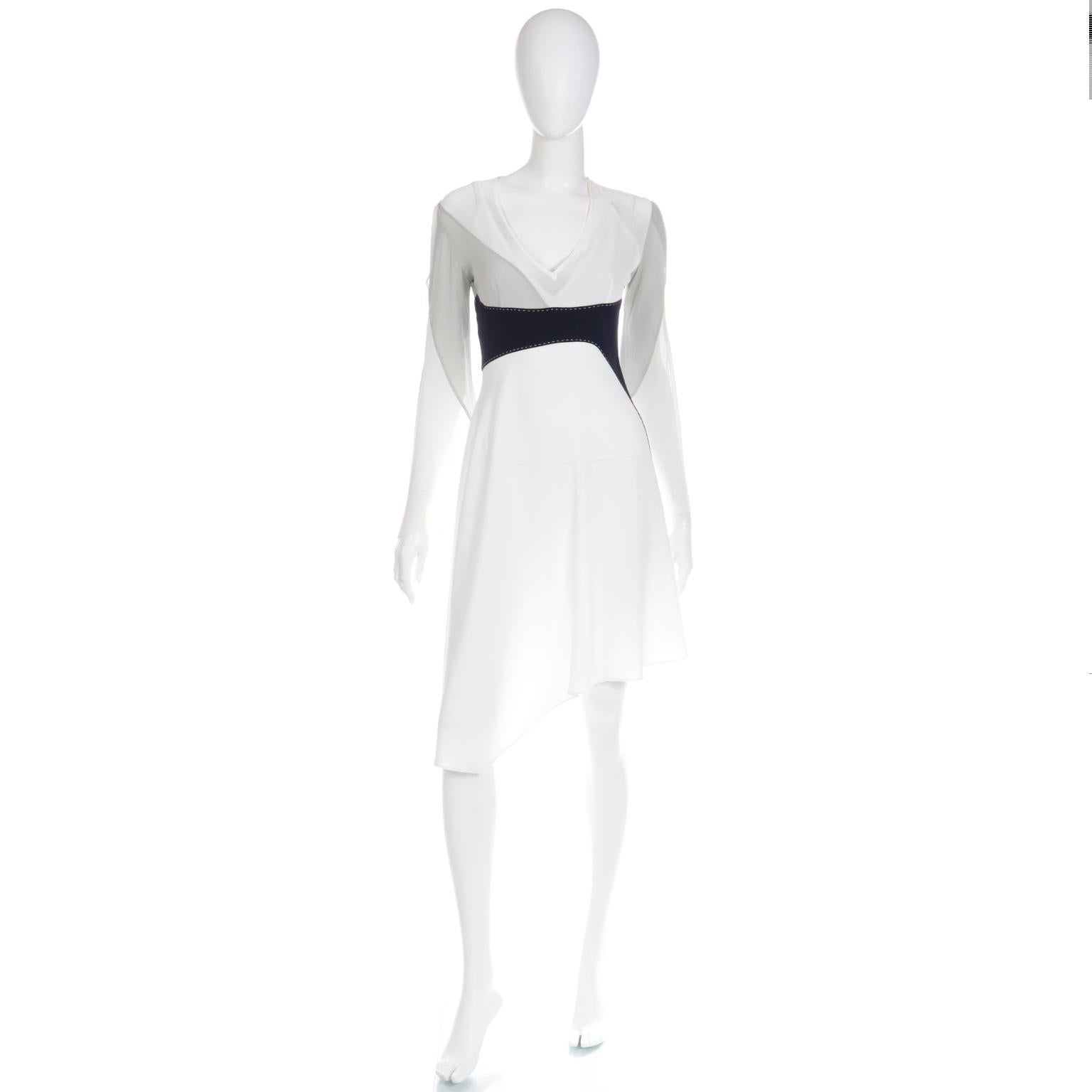 We love this this lovely Gattinoni Tempo silk vintage dress. This avant garde dress is in a fine silk crepe in color blocked shades of white, grey and black. The black fabric has intricate white hand stitching details and we especially love the