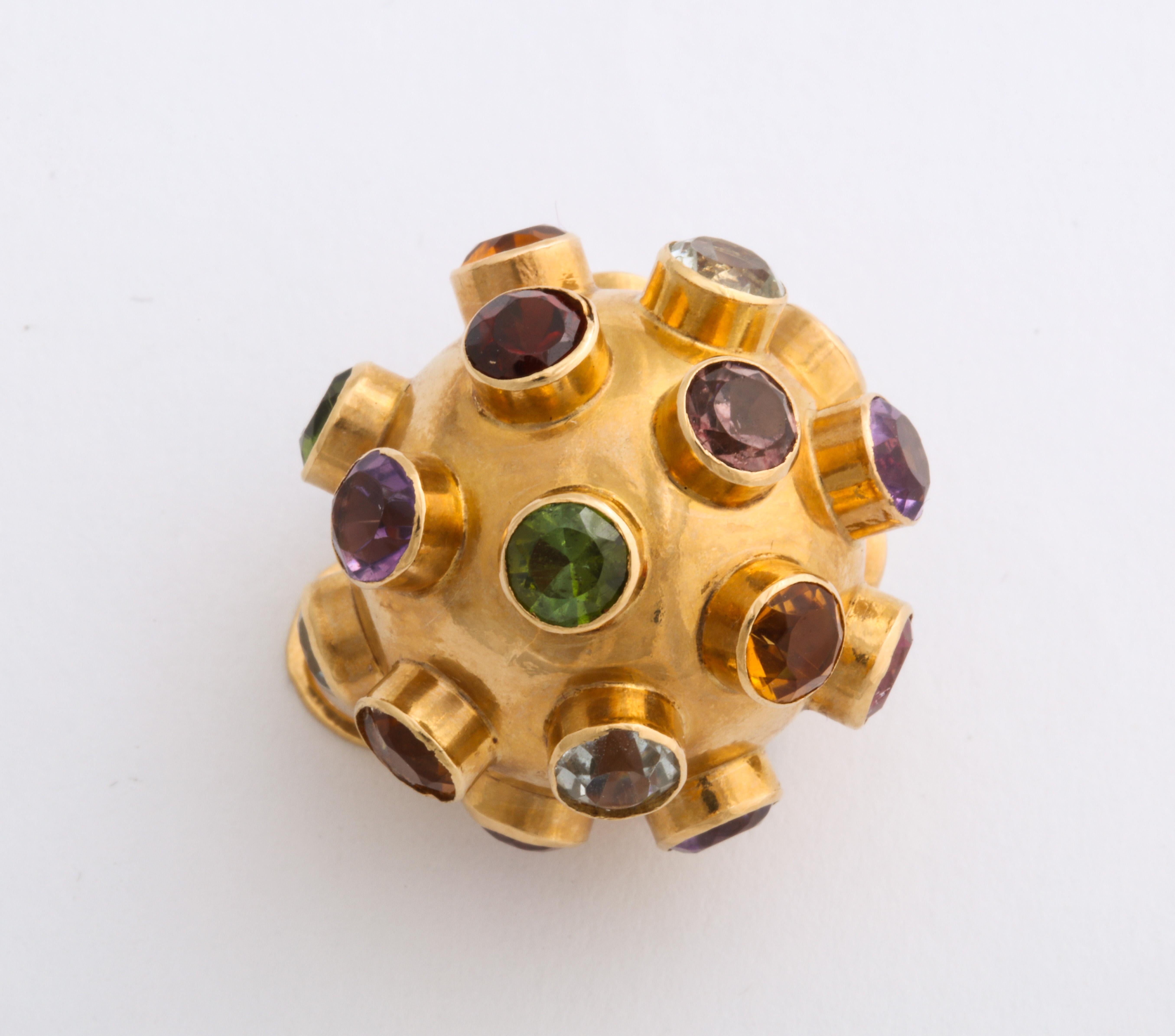 In 18 Kt, this pendant or charm, a gem studded ball, is set with colors true to their calling, garnet, aquamarine, citrine, amethyst, sapphire and green tourmaline. The stones are deeply set, each in their own collet. Sputnik, the first artificial