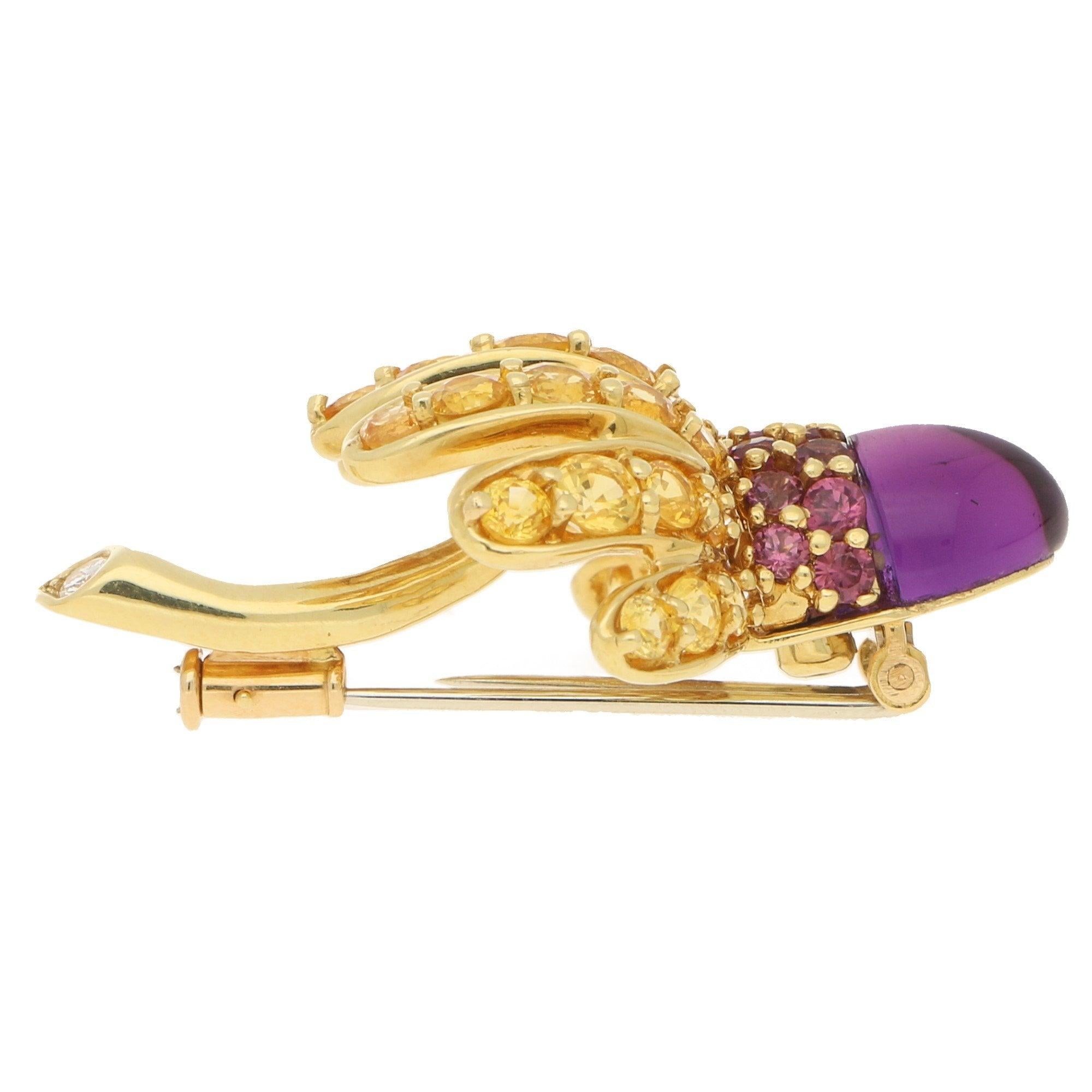 A stunning vintage Tiffany & Co. gem set thistle brooch set in 18k yellow gold. The brooch dates from 1993 and is designed as a stylised thistle. It is composed of an amethyst cabochon head surrounded by circular pink tourmaline to imitate the
