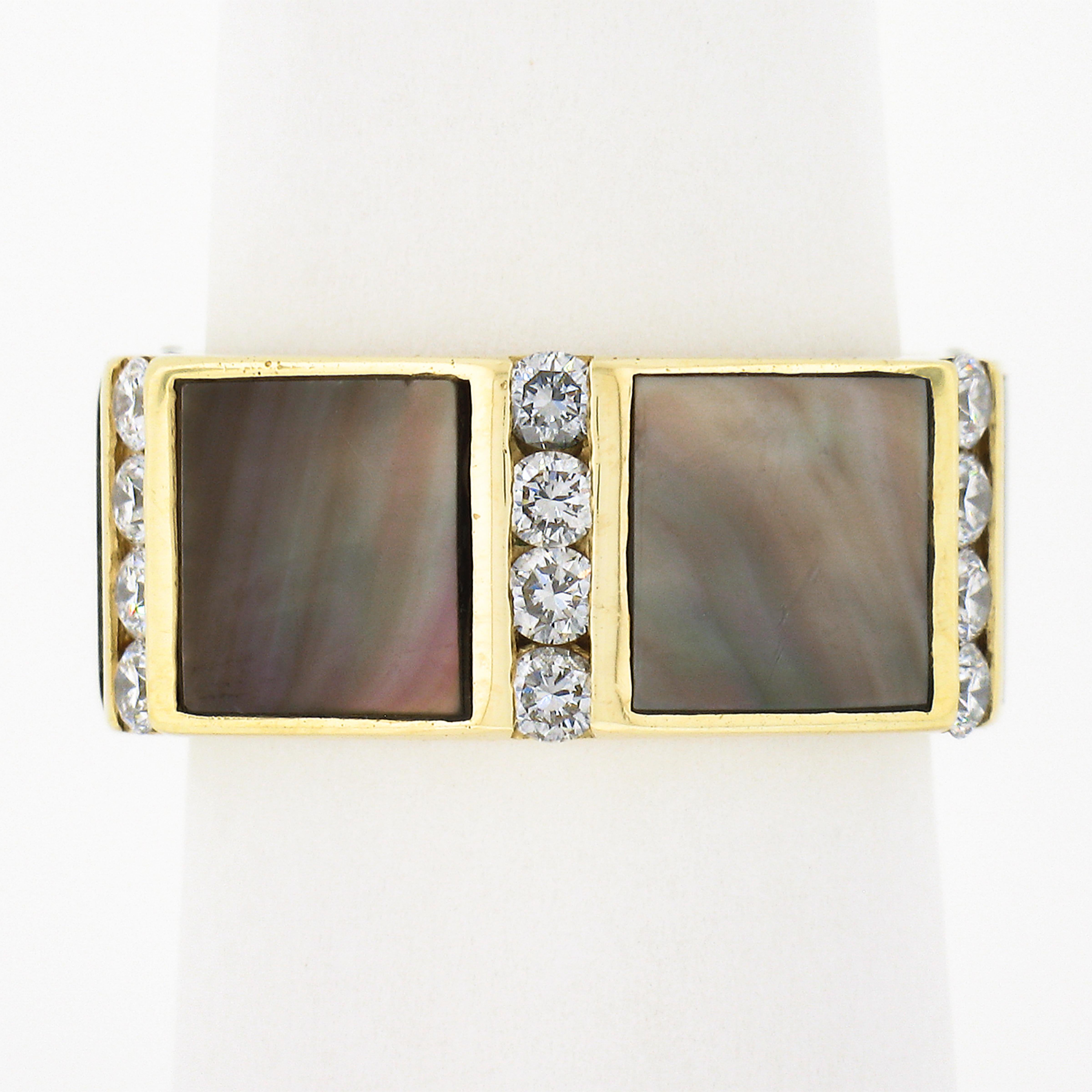 This well made vintage band ring is crafted in solid 18k yellow gold and features a wide eternity design set with beautiful black mother of pearl and diamonds entirely around the band. The mother of pearl have a custom square cut that allows them to