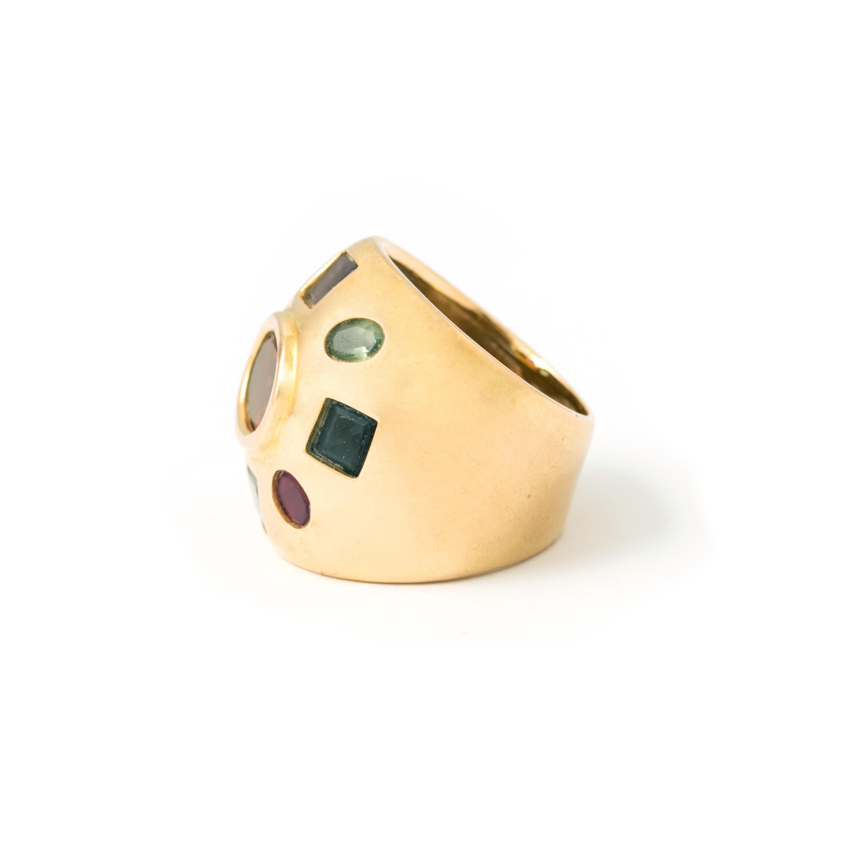 18K yellow gold ring with citrine, ruby, garnet, amethyst, peridot, emerald, aquamarine, topaz and sapphires. 
Dimensions central pattern: approximately 2.45 x 2.45 cm. 
Size: 50. 
Gross weight: 12.71 grams.