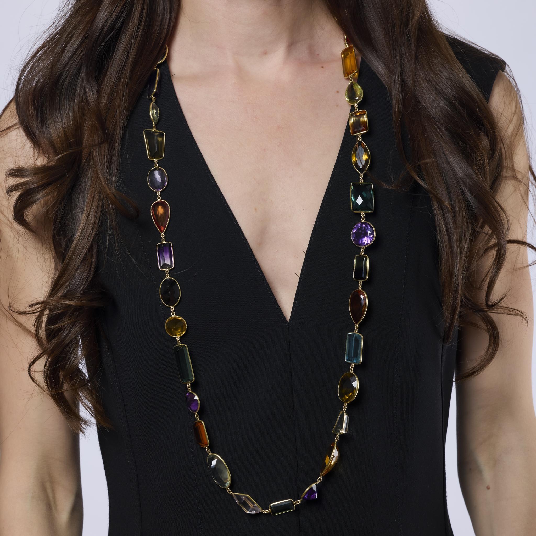 This vibrant vintage necklace features 36 colorful gemstones, including topaz, citrine, tourmaline, smoky quartz, beryl, and amethyst, set in luxurious 18k yellow gold. A bold and joyful statement piece from the glamorous 1980s.