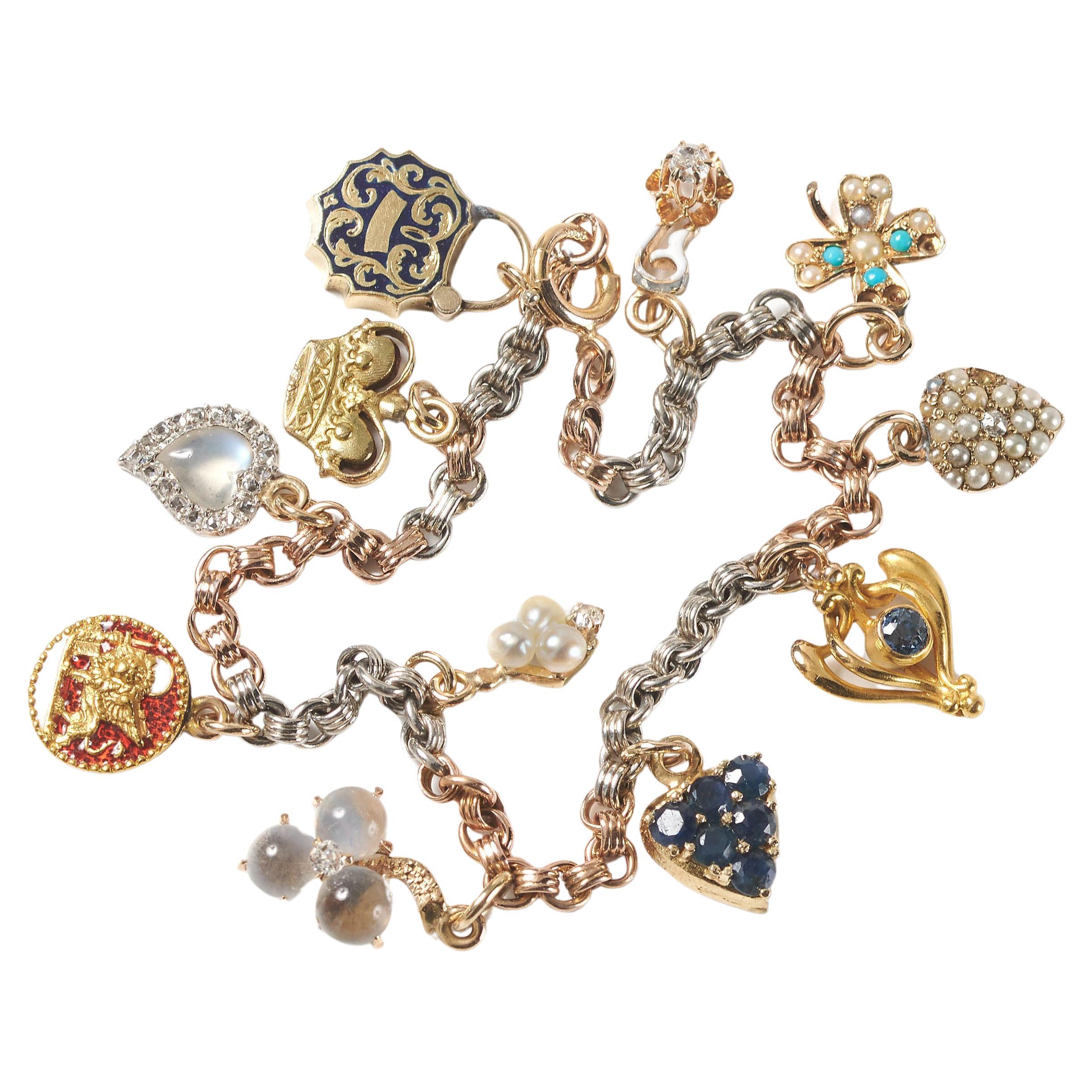 Bracelet breloque vintage en pierres précieuses, émail, or et platine