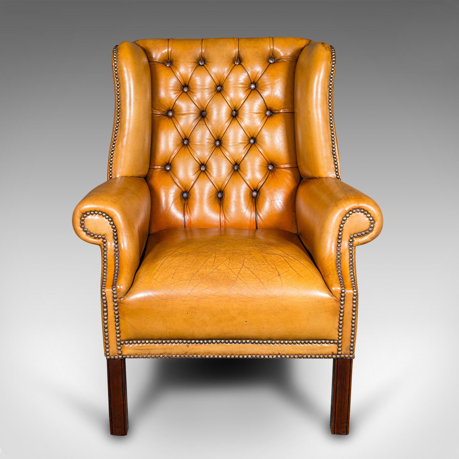 
This is a vintage gentleman's club lounge armchair. An English, leather wing back chair in Georgian revival taste, daring to the mid 20th century, circa 1950.

Captivating chair with exceptional colour and traditional comfort
Displays a desirable,